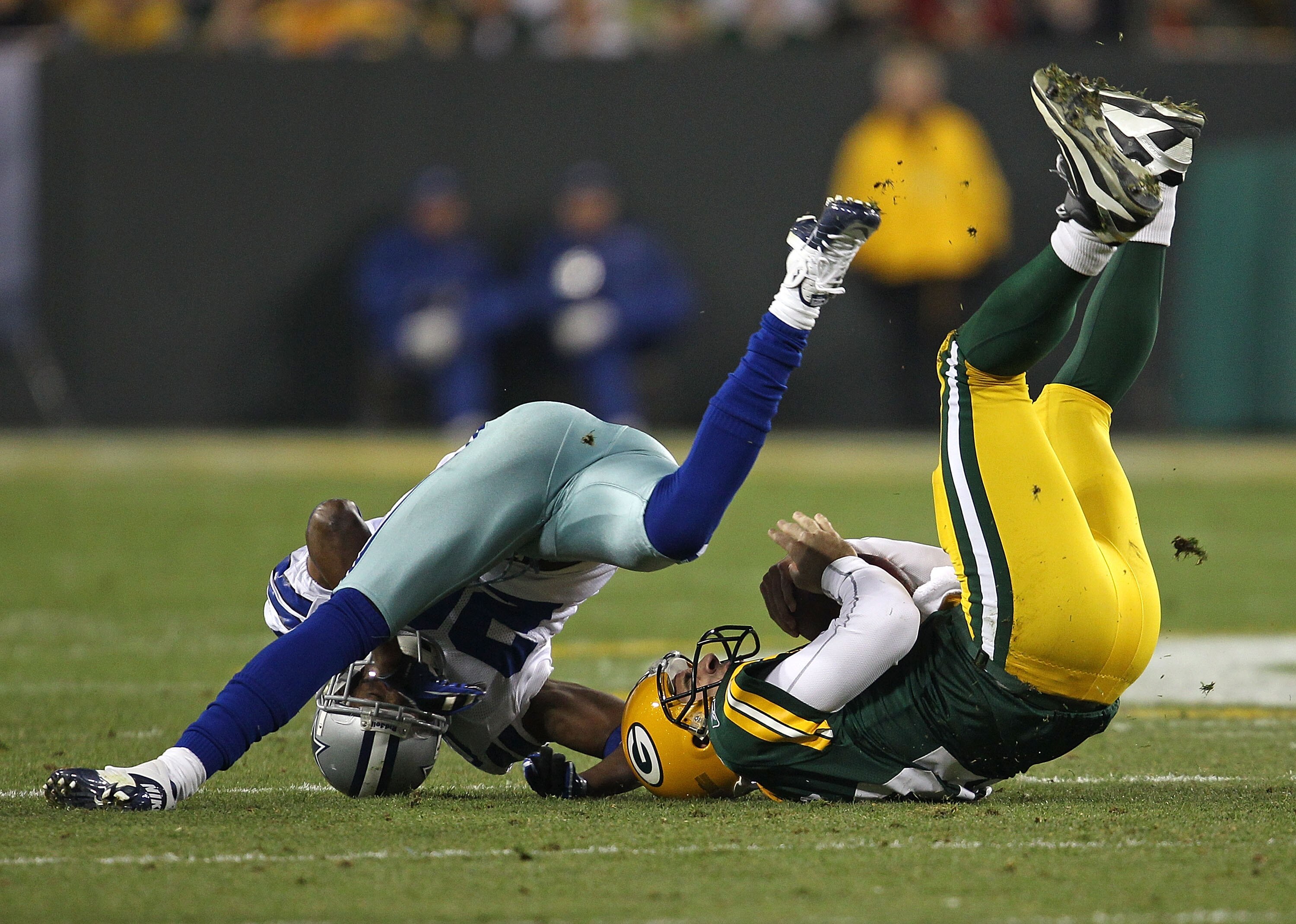 GREEN BAY, WI - NOVEMBER 07: Alan Ball #20 of the Dallas Cowboys sacks Aaron Rodgers #12 of the Green Bay Packers at Lambeau Field on November 7, 2010 in Green Bay, Wisconsin. (Photo by Jonathan Daniel/Getty Images)