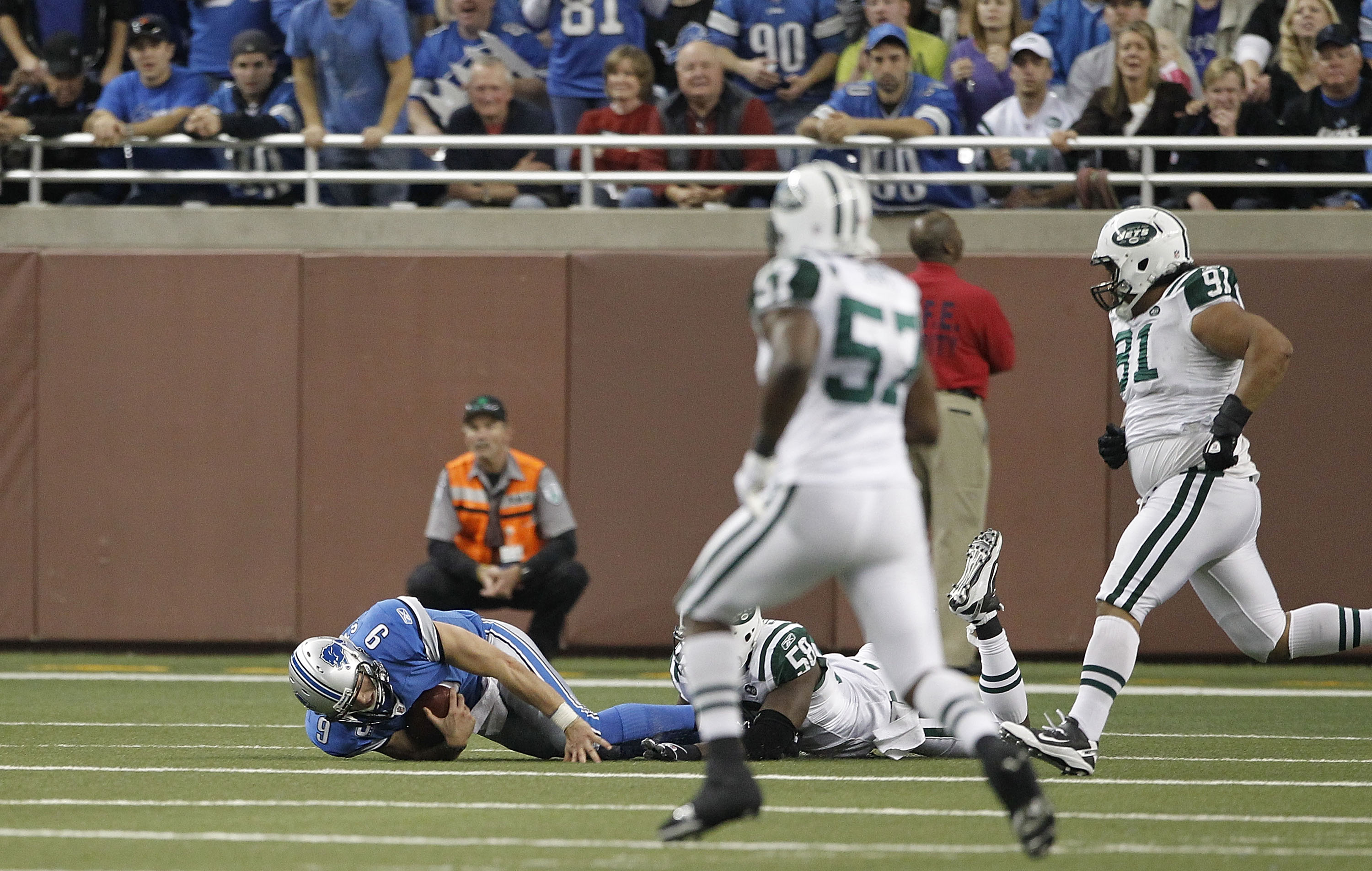 DETROIT - NOVEMBER 07:  Matthew Stafford #9 of the Detroit Lions lays on the ground after being sacked by Bryan Thomas #58 of the New York Jets during the third quarter of the game at Ford Field on November 7, 2010 in Detroit, Michigan. The Jets defeated 