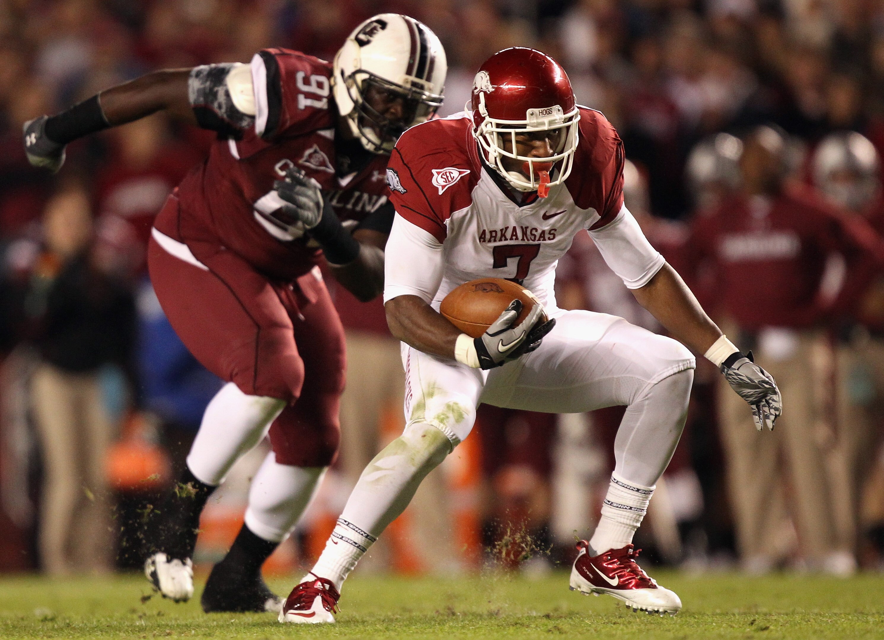 COLUMBIA, SC - NOVEMBER 06:  Knile Davis #7 of the Arkansas Razorbacks runs with the ball as Ladi Ajiboye #91 of the South Carolina Gamecocks runs after him during their game at Williams-Brice Stadium on November 6, 2010 in Columbia, South Carolina.  (Pho