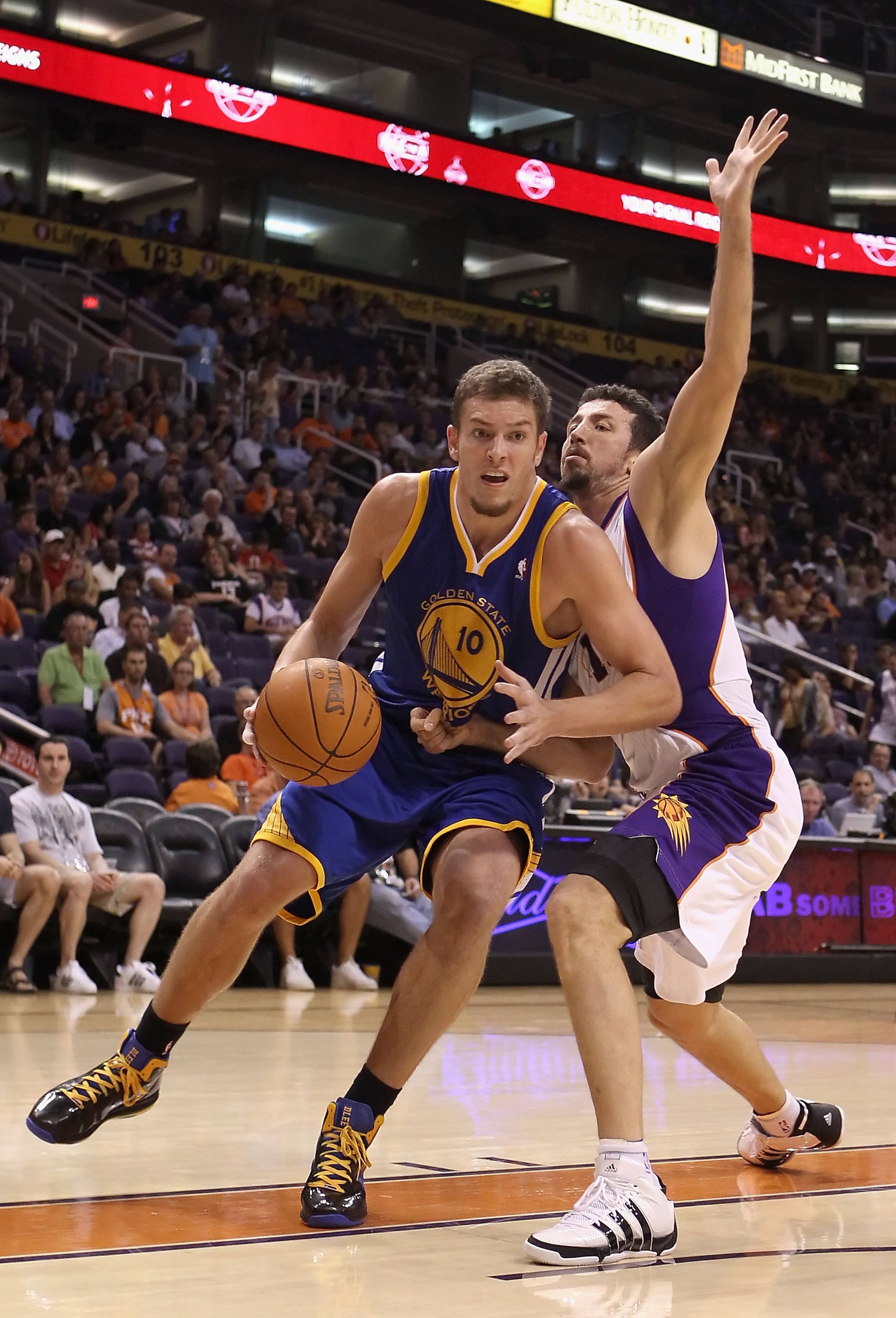 PHOENIX - OCTOBER 19:  David Lee #10 of the Golden State Warriors handles the ball under pressure from Hedo Turkoglu #19 of the Phoenix Suns during the preseason NBA game at US Airways Center on October 19, 2010 in Phoenix, Arizona. NOTE TO USER: User exp