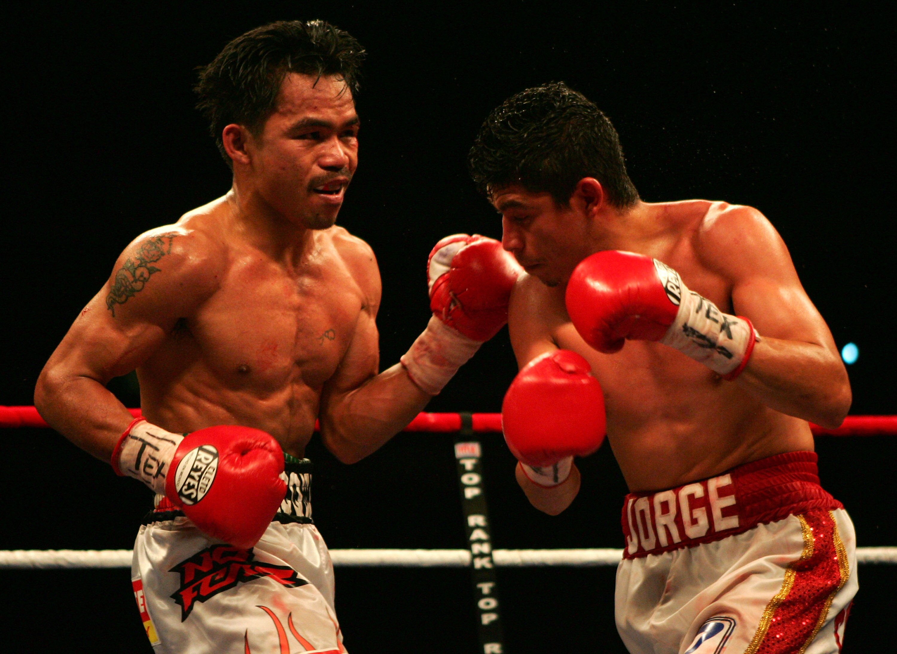 SAN ANTONIO - APRIL 14:  Manny Pacquiao of the Philippines (L) in action against Jorge Solis of Mexico during the WBC International Featherweight Championship April 14, 2007 at the Alamodome in San Antonio, Texas.  (Photo by Jed Jacobsohn/Getty Images)