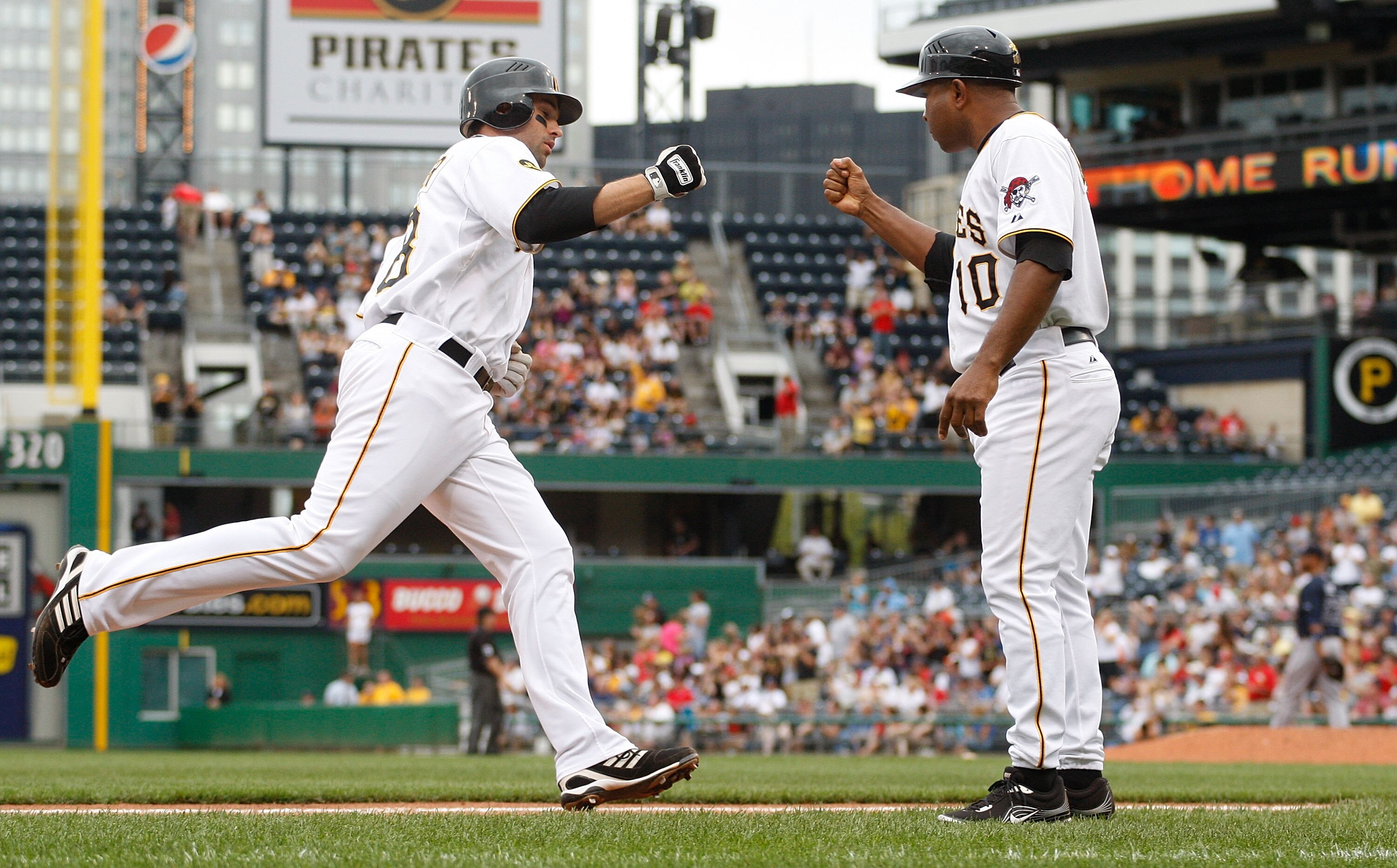 PITTSBURGH - SEPTEMBER 06:  Neil Walker #18 of the Pittsburgh Pirates is congratulated by third base coach Tony Beasley at third base after hitting a two run home run against the Atlanta Braves during the game on September 6, 2010 at PNC Park in Pittsburg