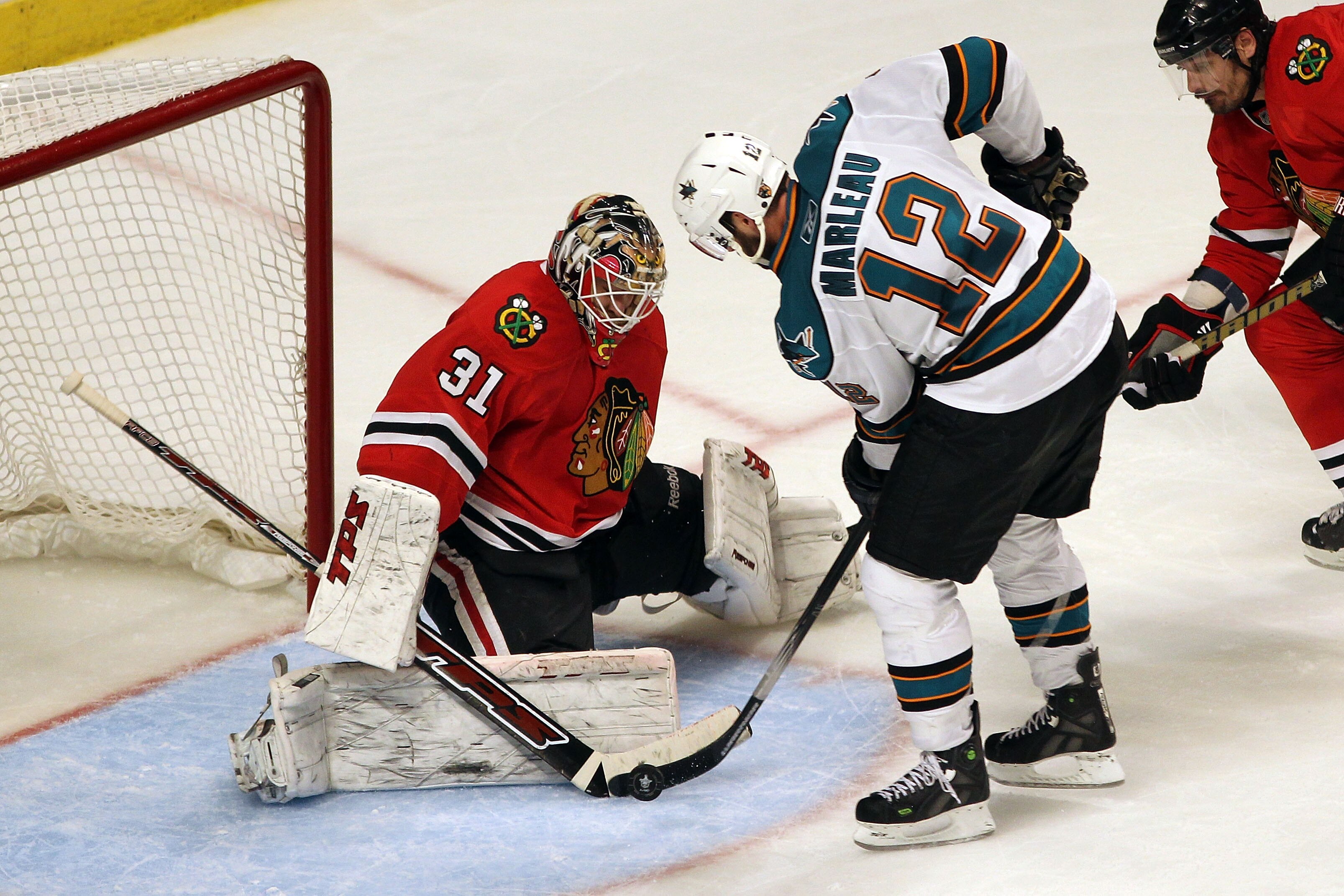CHICAGO - MAY 21:  Patrick Marleau #12 of the San Jose Sharks shoots the puck as goaltender Antti Niemi #31 of the Chicago Blackhawks makes a save in overtime of Game Three of the Western Conference Finals during the 2010 NHL Stanley Cup Playoffs at the U