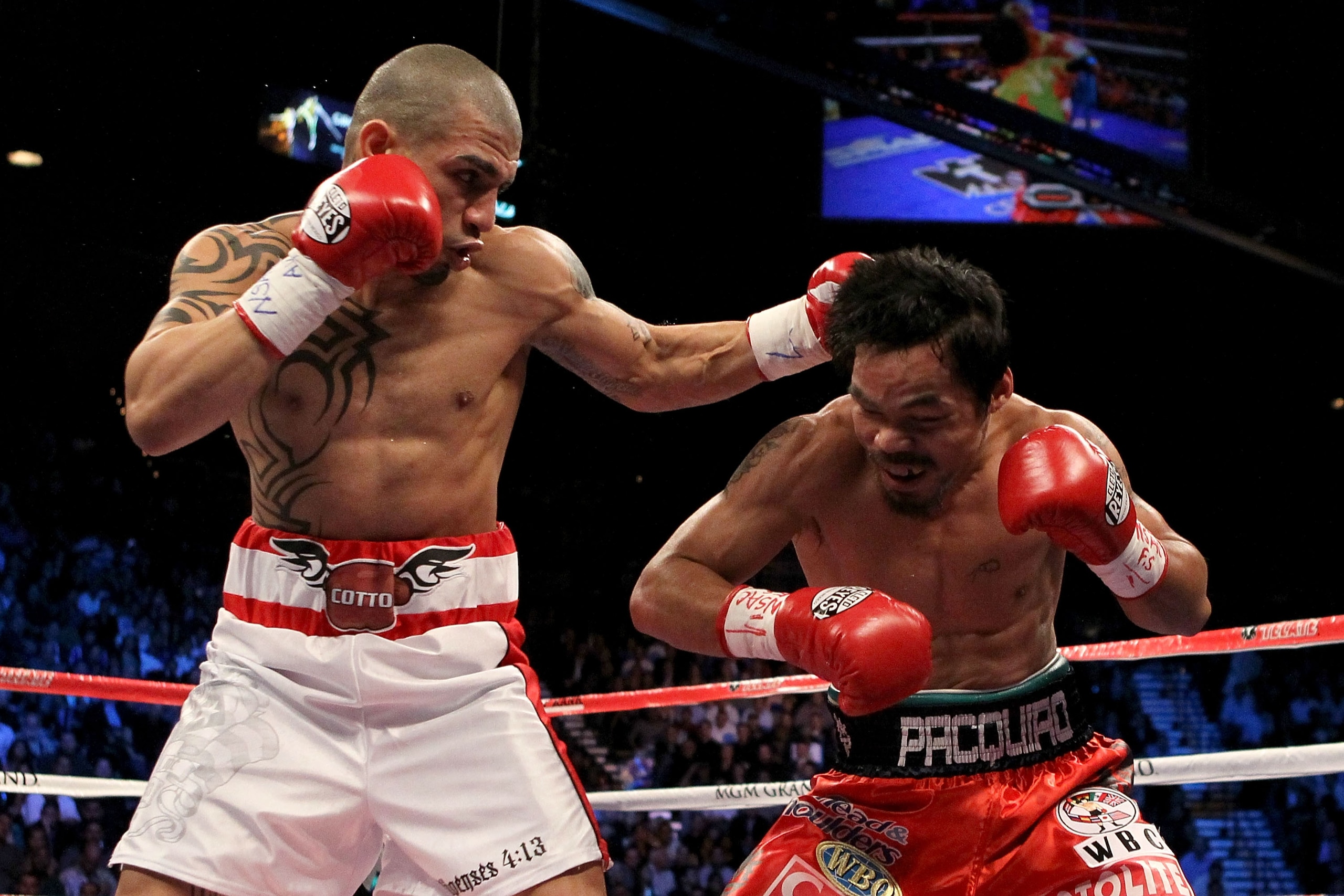 LAS VEGAS - NOVEMBER 14:  (L-R) Miguel Cotto of Puerto Rico throws a left to the head of Manny Pacquiao during their WBO welterweight title fight at the MGM Grand Garden Arena on November 14, 2009 in Las Vegas, Nevada.  (Photo by Al Bello/Getty Images)