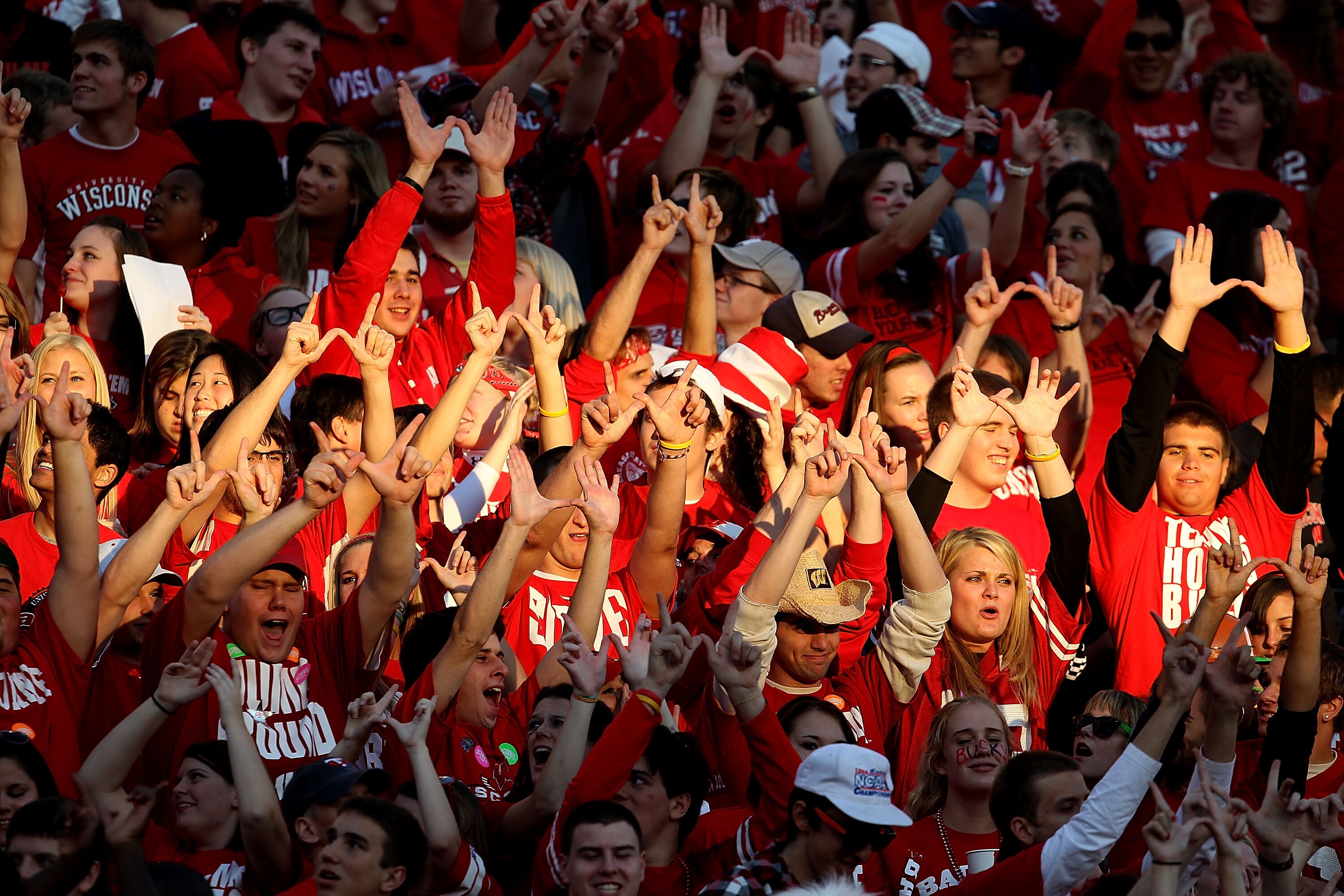 MADISON, WI - OCTOBER 16: Student fans of the Wisconsin Badgers make the 'W' sign with their hands before a game against the Ohio State Buckeyes at Camp Randall Stadium on October 16, 2010 in Madison, Wisconsin. Wisconsin defeated Ohio State 31-18. (Photo