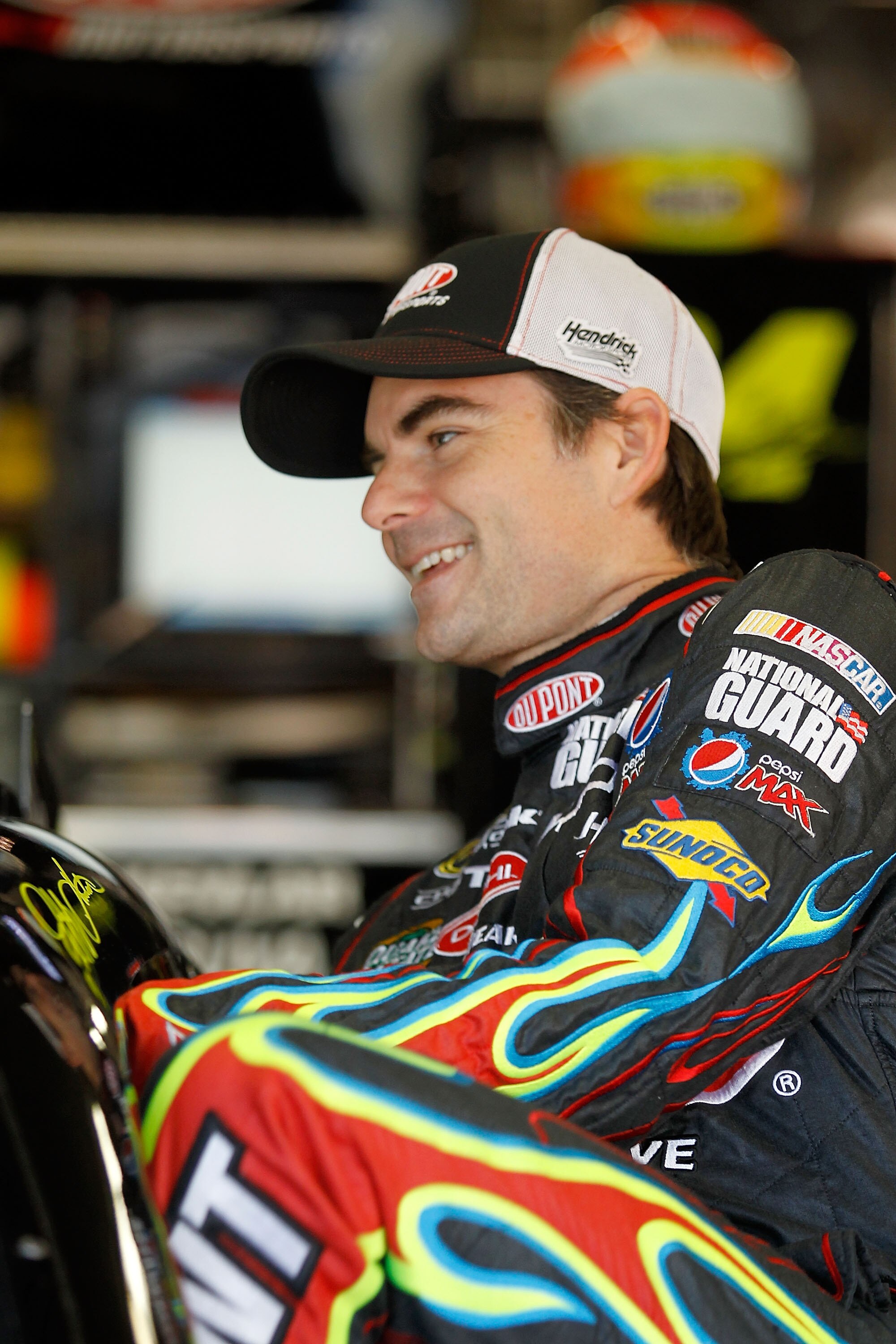 FORT WORTH, TX - NOVEMBER 06:  Jeff Gordon, driver of the #24 DuPont/National Guard Chevrolet, gets into his car in the garage area during practice for the NASCAR Sprint Cup Series AAA Texas 500 at Texas Motor Speedway on November 6, 2010 in Fort Worth, T