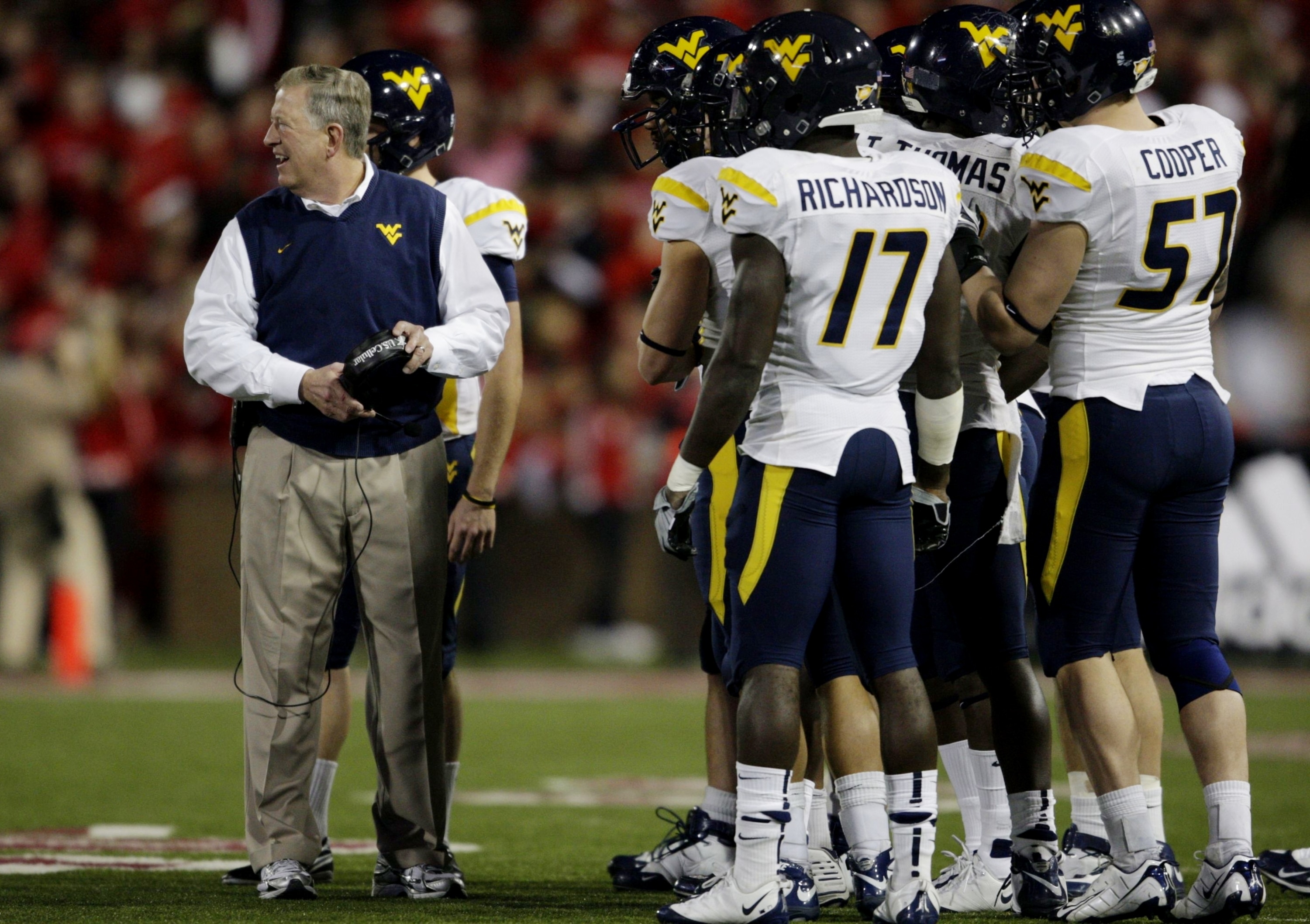 CINCINNATI - NOVEMBER 13:  Head coach Bill Stewart of the West Virginia Mountaineers meets with his team against the Cincinnati Bearcats in the second quarter at Nippert Stadium on November 13, 2009 in Cincinnati, Ohio.  (Photo by Andy Lyons/Getty Images)