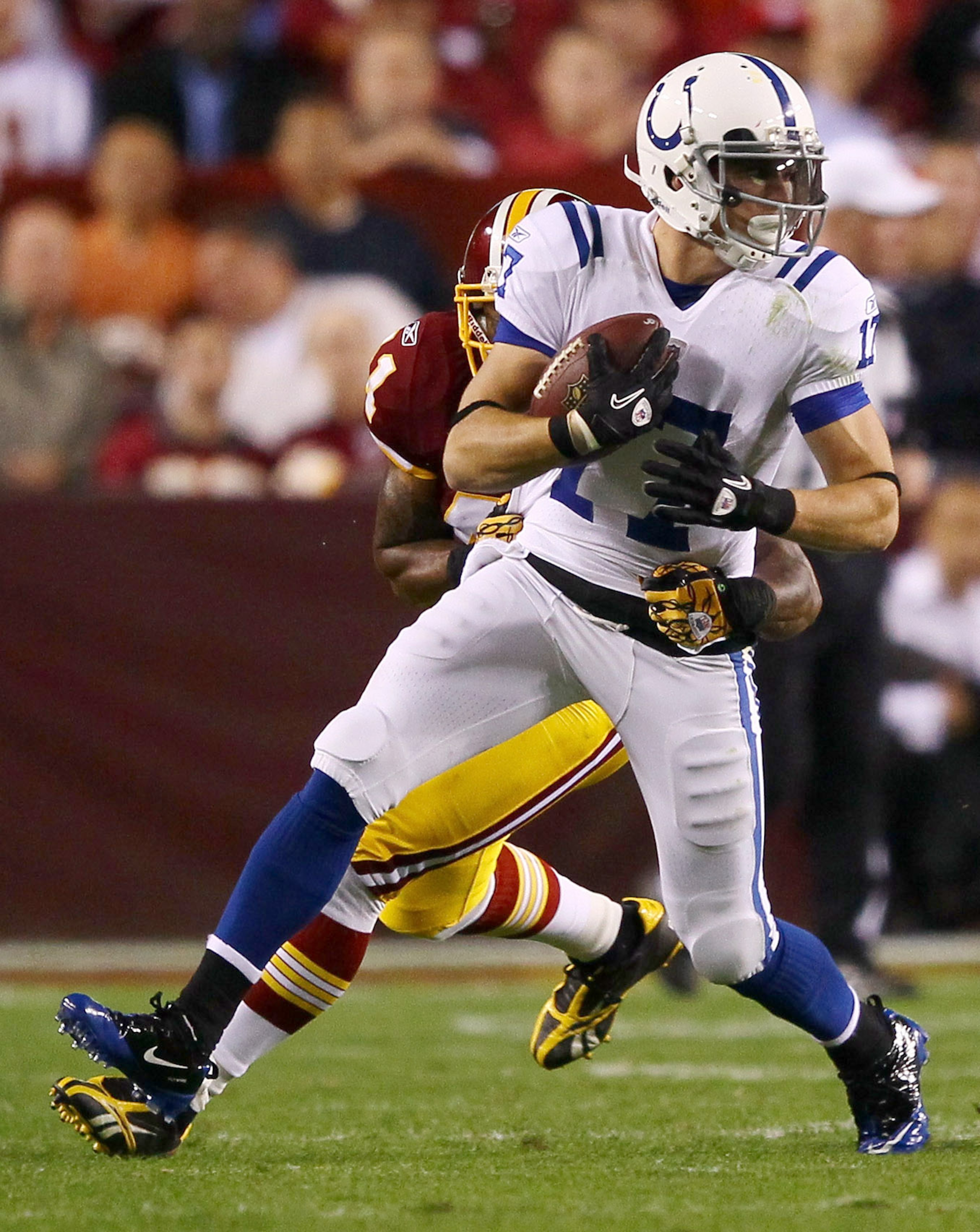 LANDOVER, MD - OCTOBER 17: Austin Collie #17 of the Indianapolis Colts moves the ball upfield after making a reception against Kareem Moore #41 of the Washington Redskins at FedExField on October 17, 2010 in Landover, Maryland. (Photo by Win McNamee/Get LANDOVER, MD - OCTOBER 17: Austin Collie #17 of the Indianapolis Colts moves the ball upfield after making a reception against Kareem Moore #41 of the Washington Redskins at FedExField on October 17, 2010 in Landover, Maryland. (Photo by Win McNamee/Get