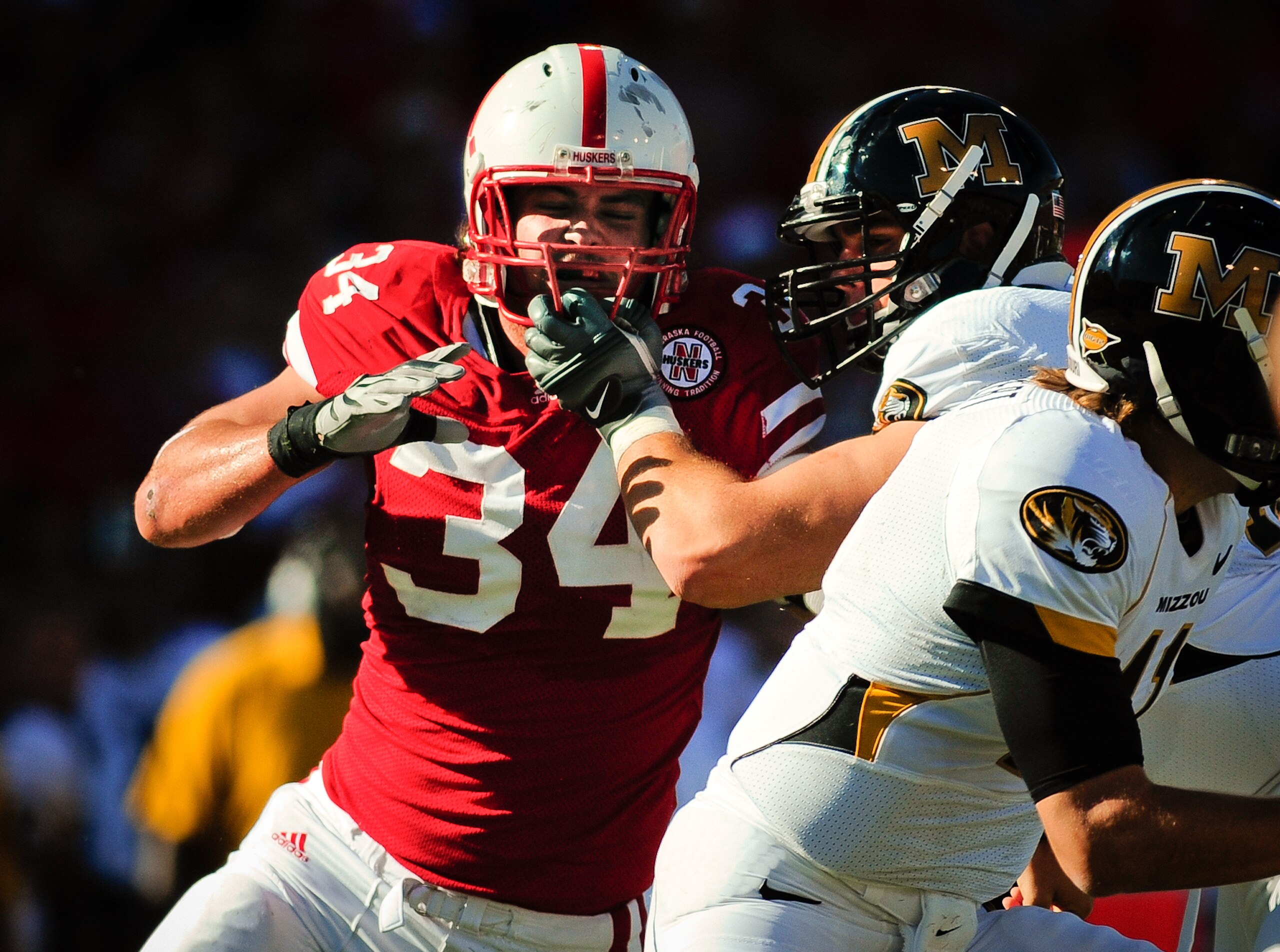 LINCOLN, NE - OCTOBER 30: Defensive end Cameron Meredith #34 of the Nebraska Cornhuskers  tries to beat offensive linesman Elvis Fisher #72 of the Missouri Tigers during first half action of their game at Memorial Stadium on October 30, 2010 in Lincoln, N