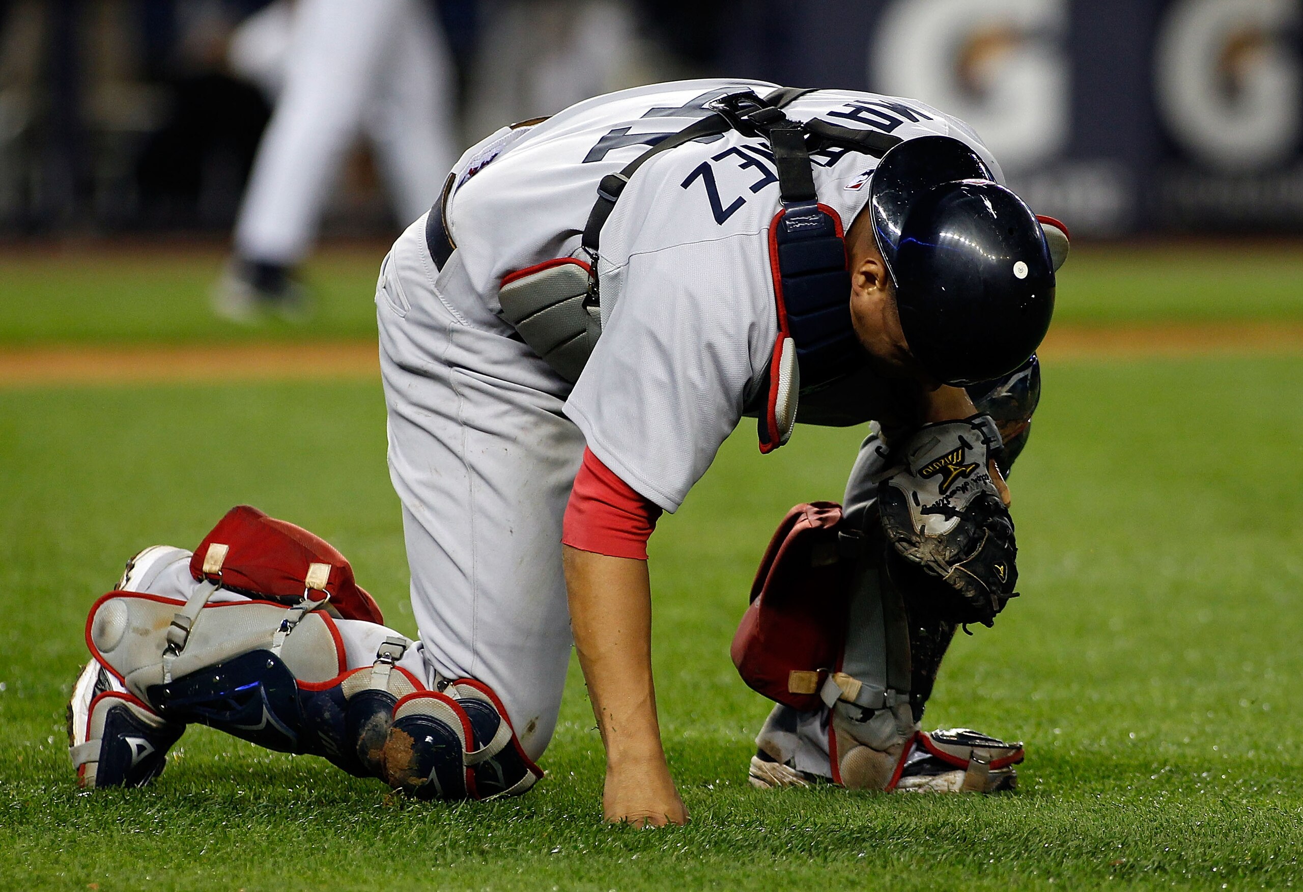 NEW YORK - SEPTEMBER 26:  Victor Martinez #41 of the Boston Red Sox kneels in pain after throwing the ball away for an error on Brett Gardner (not shown) of the New York Yankees bunt attempt in the 10th inning on September 26, 2010 at Yankee Stadium in th