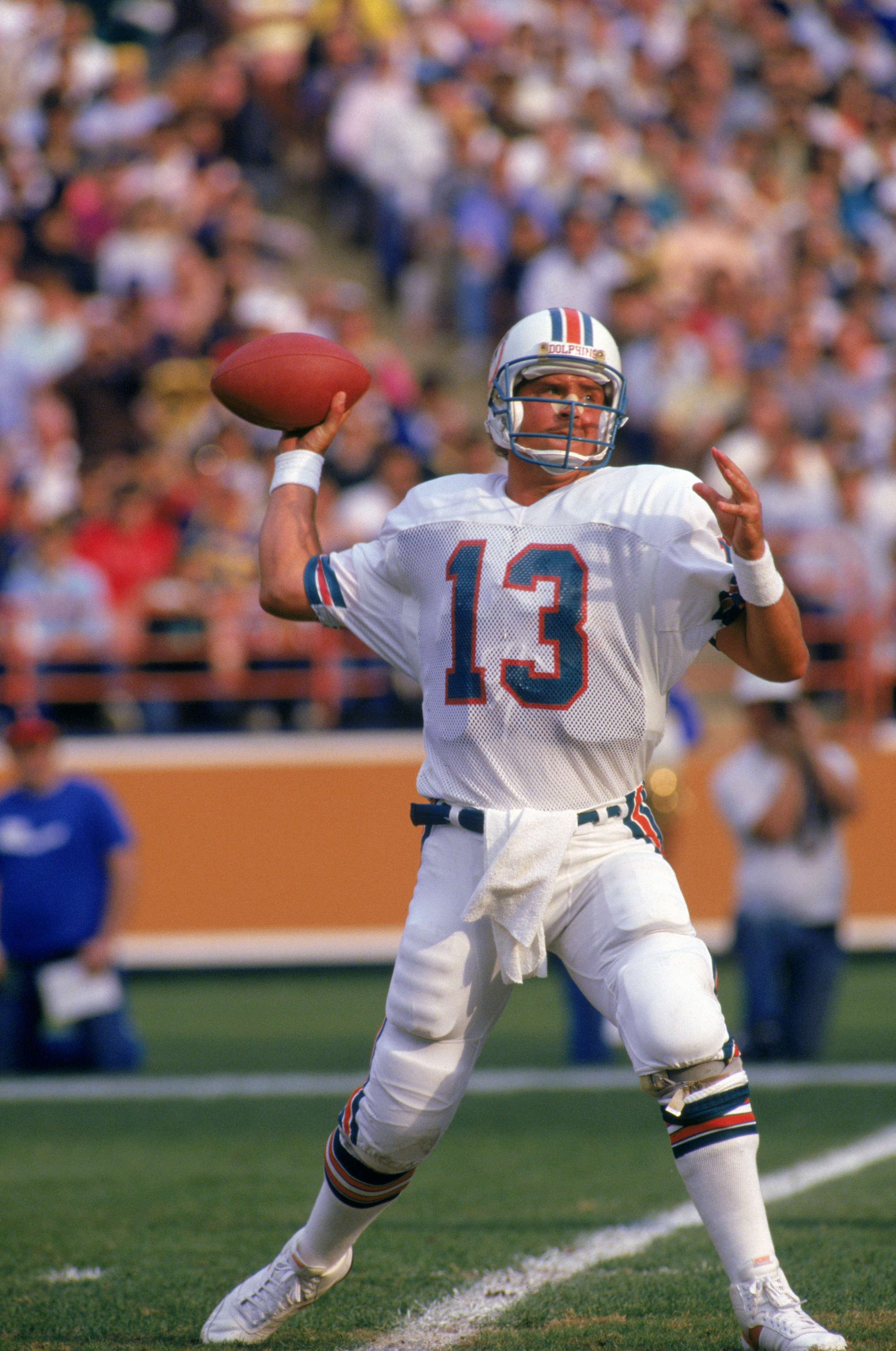 ANAHEIM, CA - DECEMBER 14:  Quarterback Dan Marino #13 of the Miami Dolphins throw a pass during a game against the Los Angeles Rams at Anaheim Stadium on December 14, 1986 in Anaheim, California.   The Dolphins won 37-31 in overtime.  (Photo by George Ro