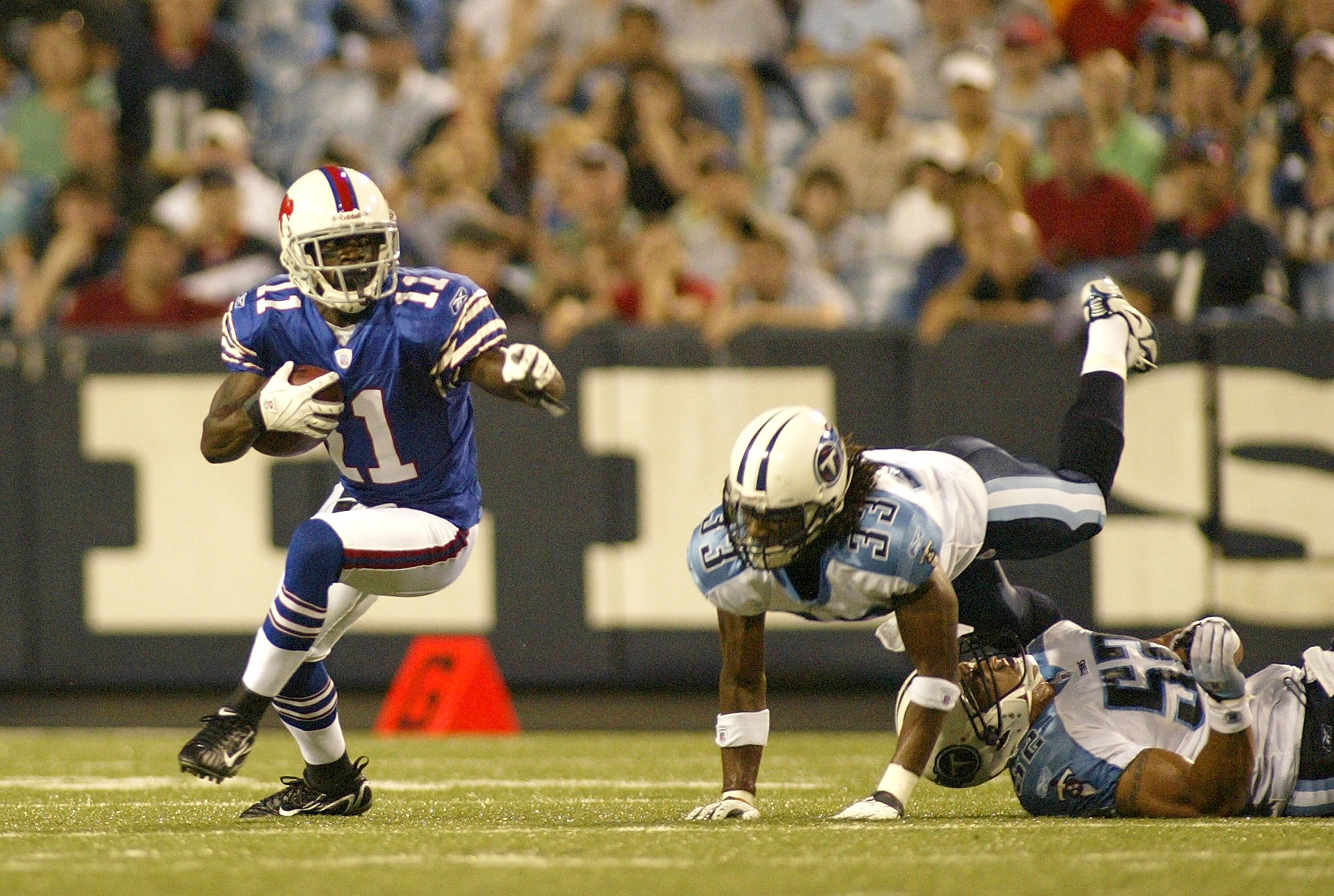 ORCHARD PARK - AUGUST 24:  Roscoe Parish #11 of the Buffalo Bills runs ahead of Michael Griffin #33 of the Tennessee Titans at a preseason game at Ralph Wilson Stadium August 24, 2007 in Orchard Park, New York.  (Photo by Rick Stewart/Getty Images)