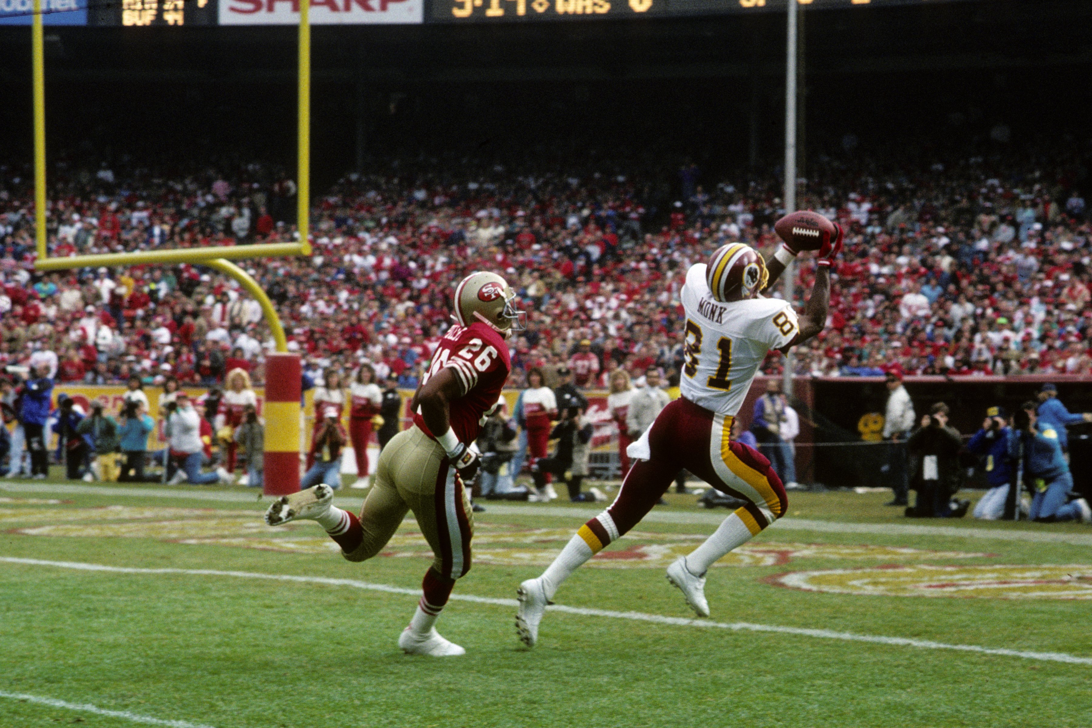 SAN FRANCISCO, CA - JANUARY 12:  Wide receiver Art Monk #81 of the Washington Redskins catches a 31 yard touchdown pass from Mark Rypien (Not Shown) against defensive back Darryl Pollard #26 of the San Francisco 49ers during the 1990 NFC Divisional Playof