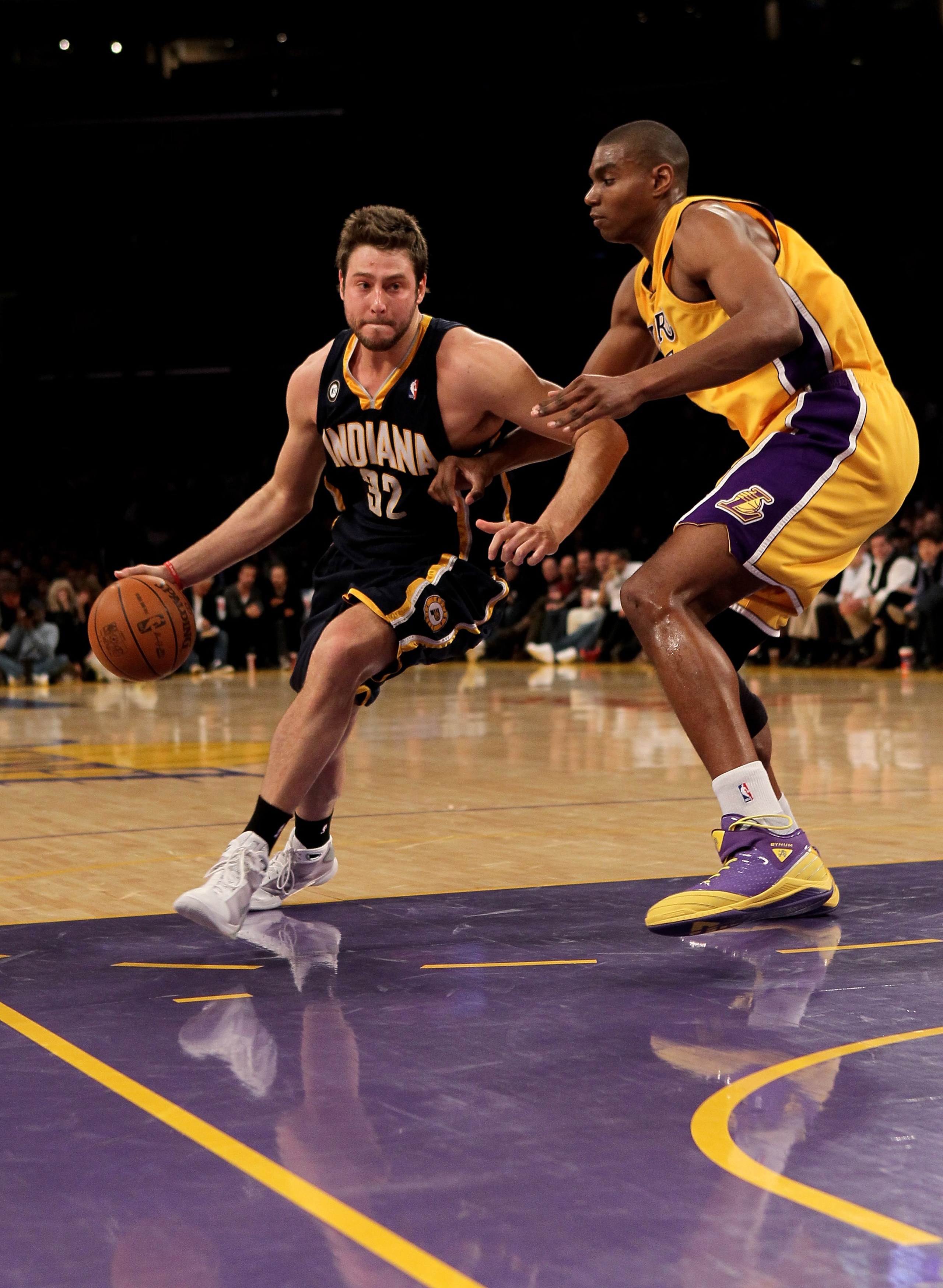 LOS ANGELES - MARCH 2:  Josh McRoberts #32 of the Indiana Pacers drives around Andrew Bynum #16 of the Los Angeles Lakers on March 2, 2010 at Staples Center in Los Angeles, California. The Lakers won 122-99.  NOTE TO USER: User expressly acknowledges and 