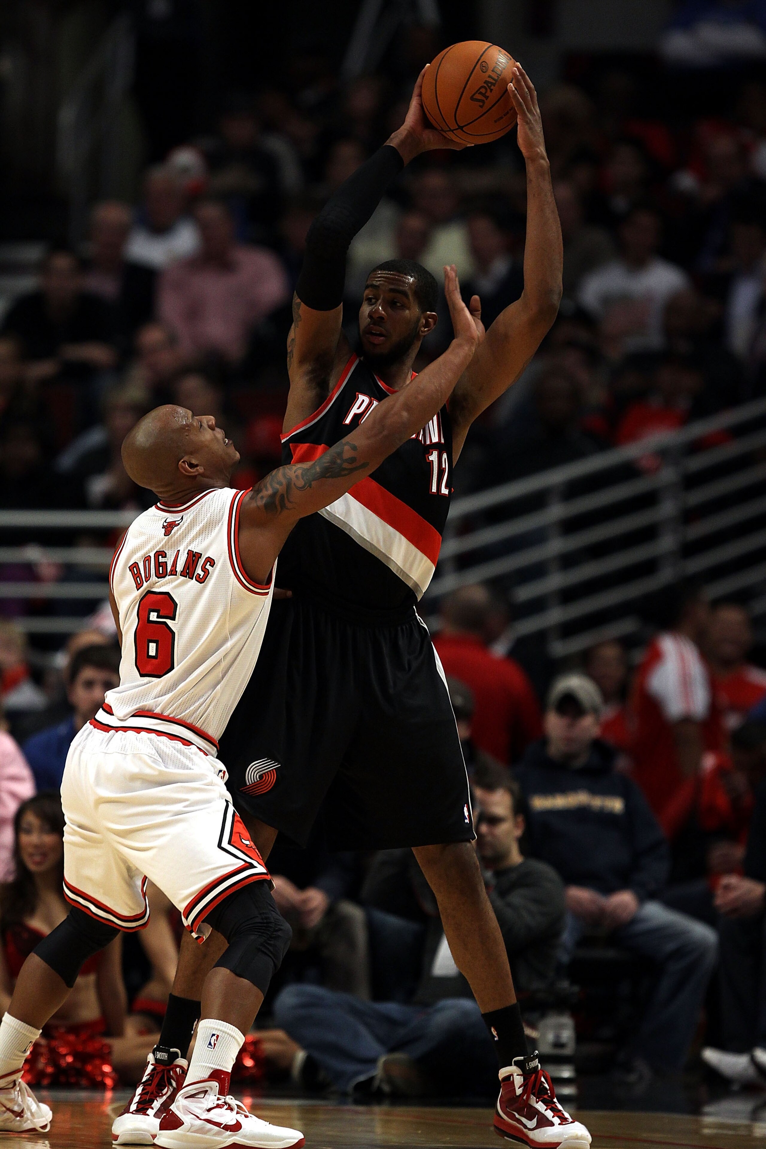 CHICAGO - NOVEMBER 01: LaMarcus Aldridge #12 of the Portland Trail Blazers looks to pass under pressure from Keith Bogans #6 of the Chicago Bulls at the United Center on November 1, 2010 in Chicago, Illinois. The Bulls defeated the Trail Blazers 110-98. N