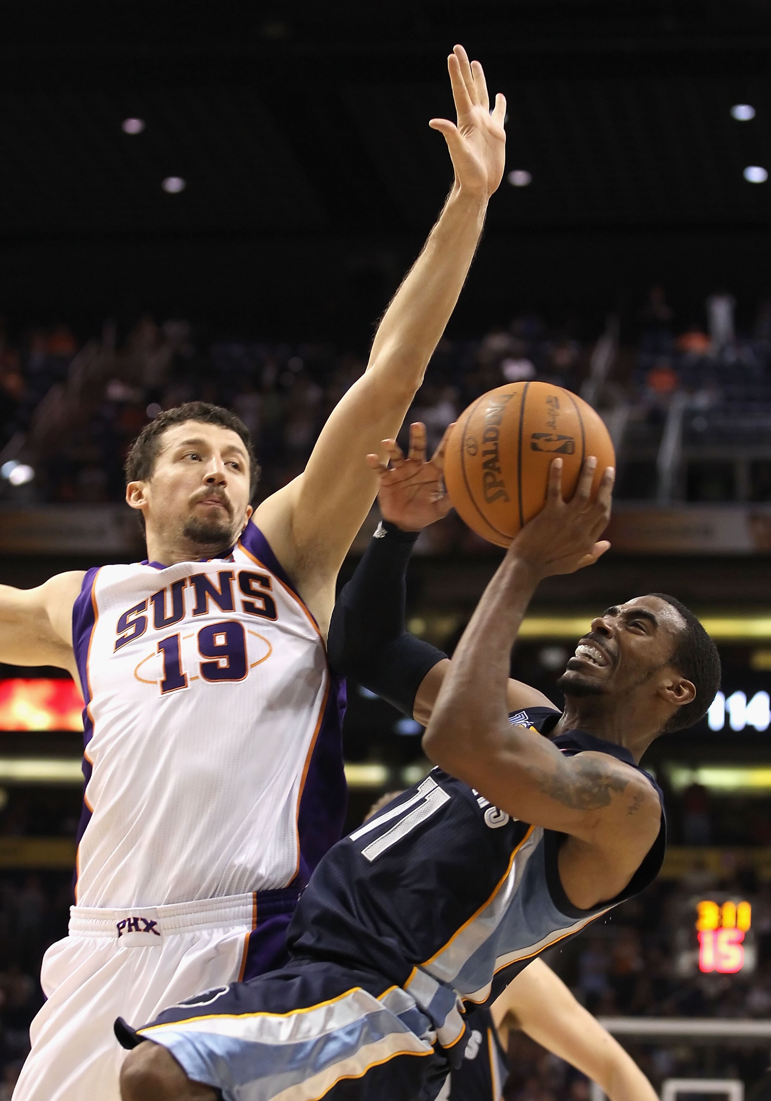 PHOENIX - NOVEMBER 05:  Mike Conley #11 of the Memphis Grizzlies puts up a shot against Hedo Turkoglu #19 of the Phoenix Suns during the NBA game at US Airways Center on November 5, 2010 in Phoenix, Arizona. The Suns defeated the Grizzlies 123-118 in doub