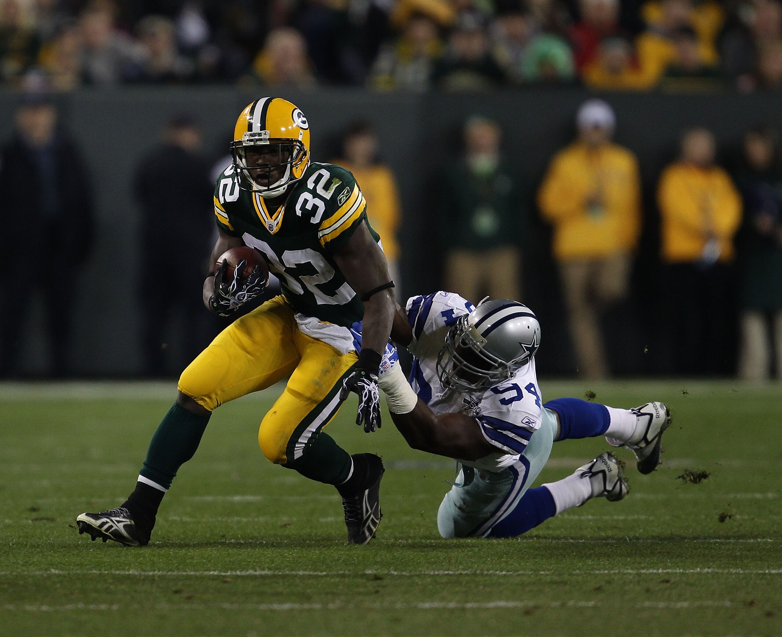 GREEN BAY, WI - NOVEMBER 07: Brandon Jackson #32 of the Green Bay Packers breaks away from DeMarcus Ware #94 of the Dallas Cowboys at Lambeau Field on November 7, 2010 in Green Bay, Wisconsin. The Packers defeated the Cowboys 45-7. (Photo by Jonathan Dan GREEN BAY, WI - NOVEMBER 07: Brandon Jackson #32 of the Green Bay Packers breaks away from DeMarcus Ware #94 of the Dallas Cowboys at Lambeau Field on November 7, 2010 in Green Bay, Wisconsin. The Packers defeated the Cowboys 45-7. (Photo by Jonathan Dan