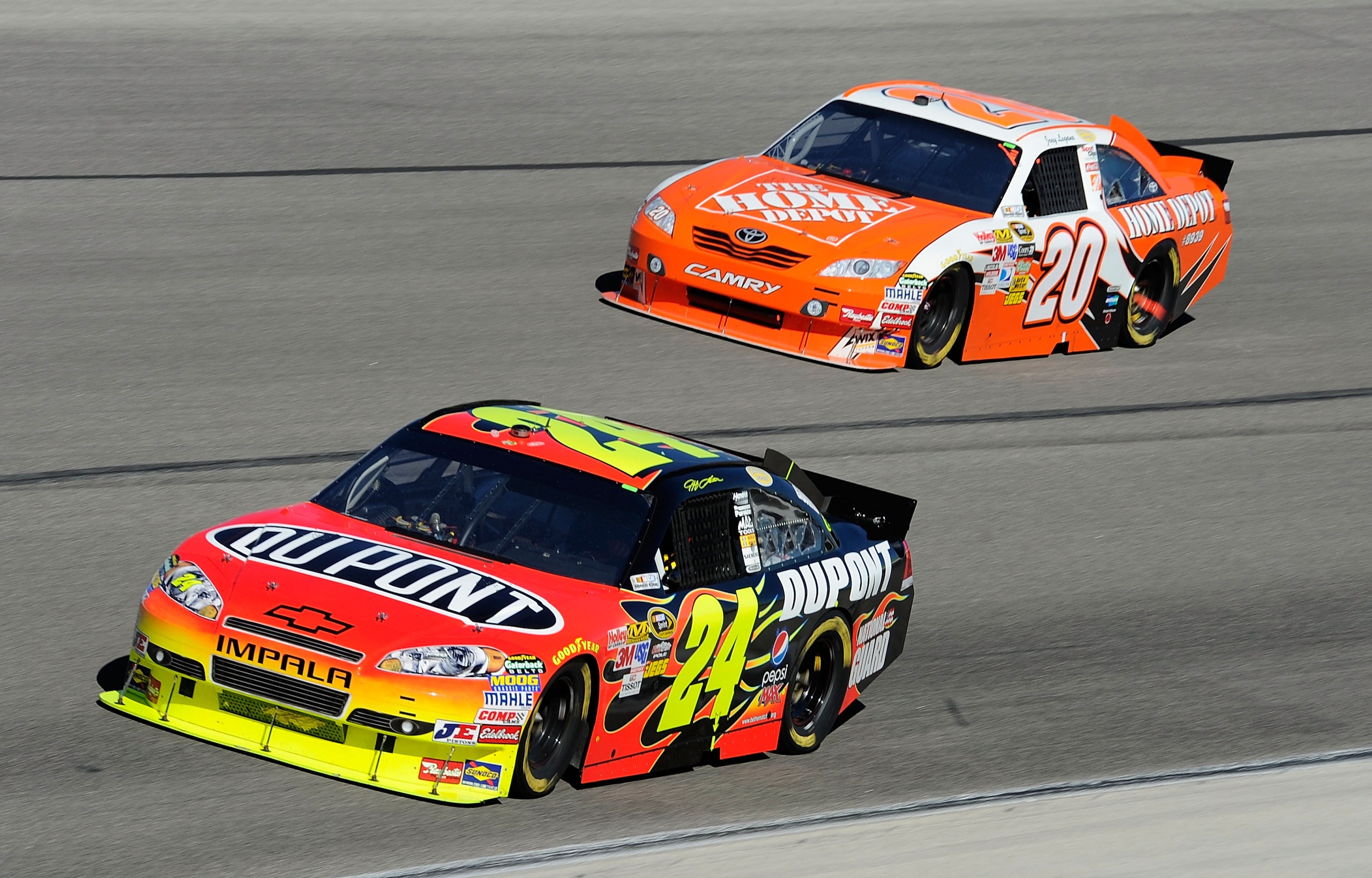 FORT WORTH, TX - NOVEMBER 07:  Jeff Gordon, driver of the #24 DuPont/National Guard Chevrolet, leads Joey Logano, driver of the #20 Home Depot Toyota, during the NASCAR Sprint Cup Series AAA Texas 500 at Texas Motor Speedway on November 7, 2010 in Fort Wo