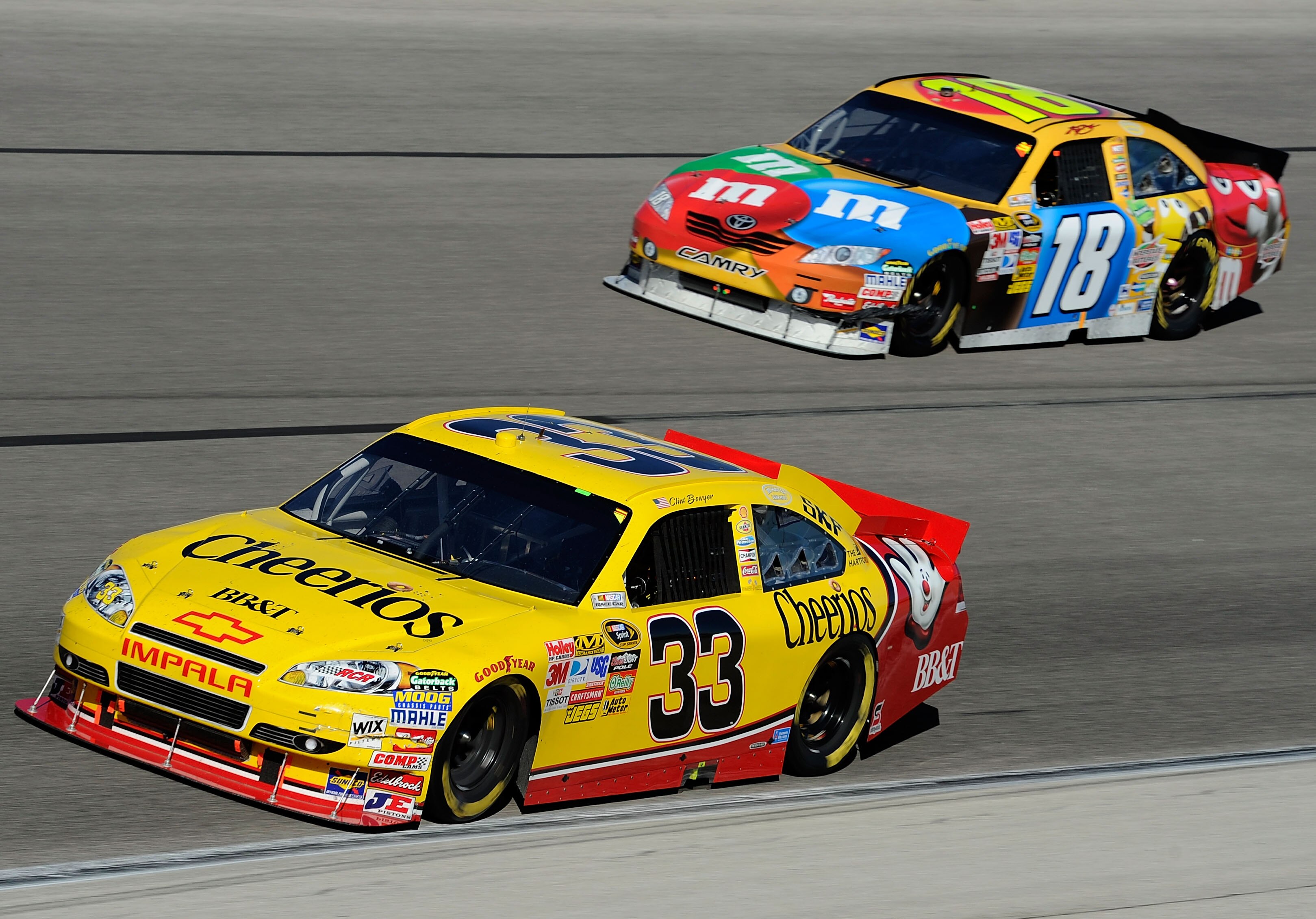 FORT WORTH, TX - NOVEMBER 07:  Clint Bowyer, driver of the #33 BB&T Chevrolet, races Kyle Busch, driver of the #18 M&M's Toyota, during the NASCAR Sprint Cup Series AAA Texas 500 at Texas Motor Speedway on November 7, 2010 in Fort Worth, Texas.  (Photo by