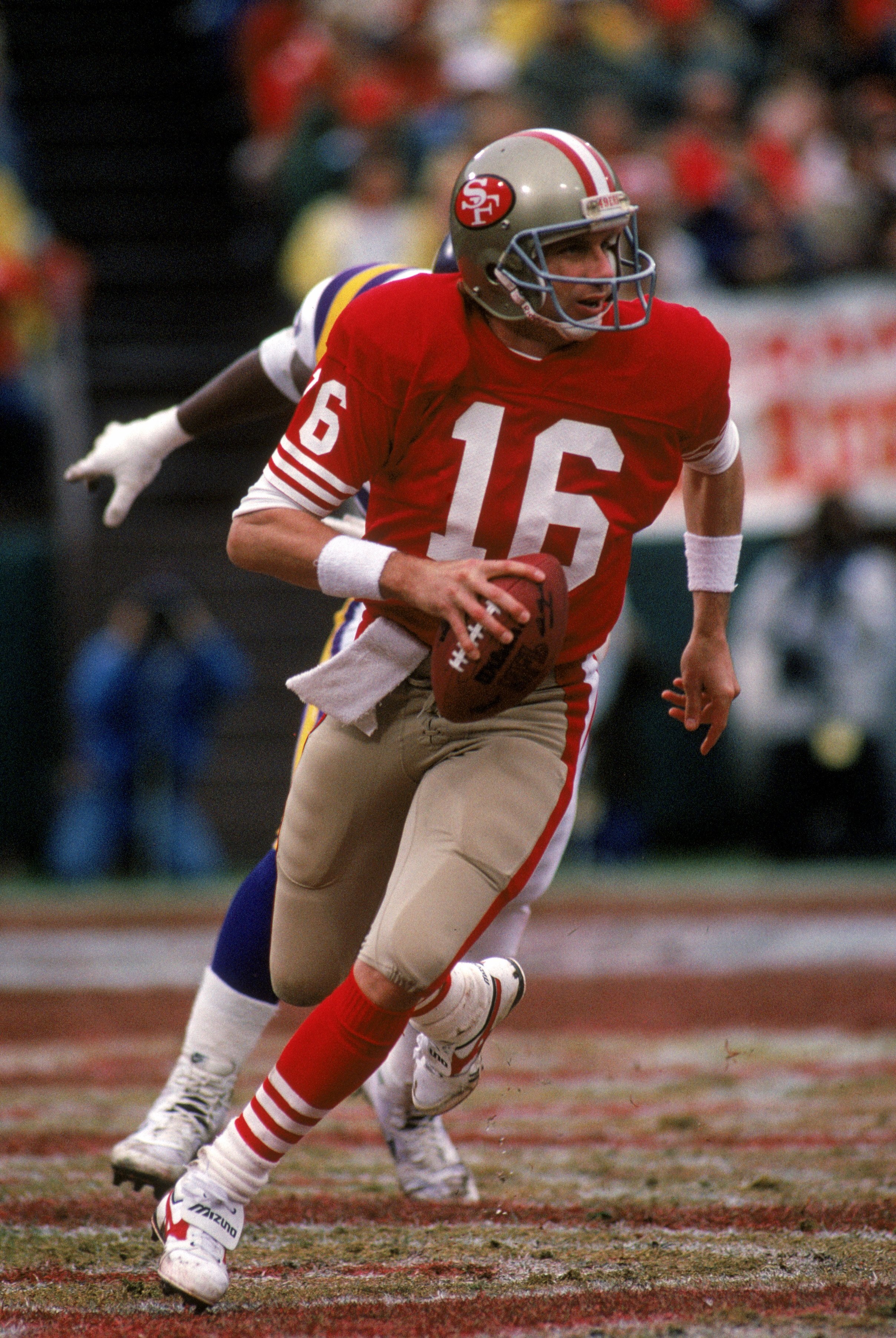 SAN FRANCISCO - JANUARY 9:  Quarterback Joe Montana #16 of the San Francisco 49ers runs with the ball as he looks down field for a receiver during the 1987 NFC Divisional Playoff game against the Minnesota Vikings at Candlestick Park on January 9, 1988 in