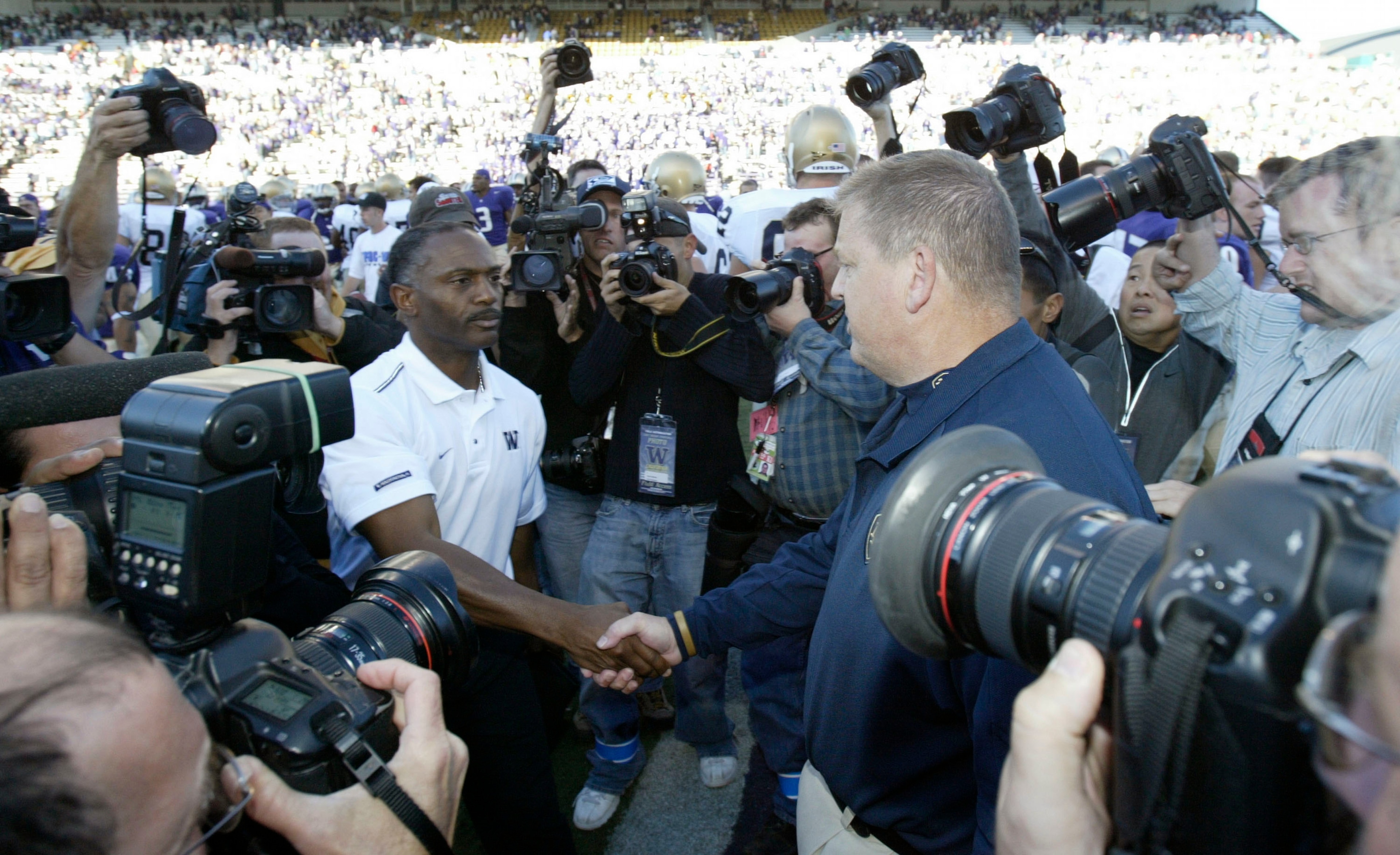 SEATTLE - SEPTEMBER 24:  Head Coach Tyrone Willingham of the Washington Huskies (L) shakes hands after the game with Head Coach Charlie Weis of the Notre Dame Fighting Irish on September 24, 2005 at Husky Stadium in Seattle, Washington. The Irish defeated
