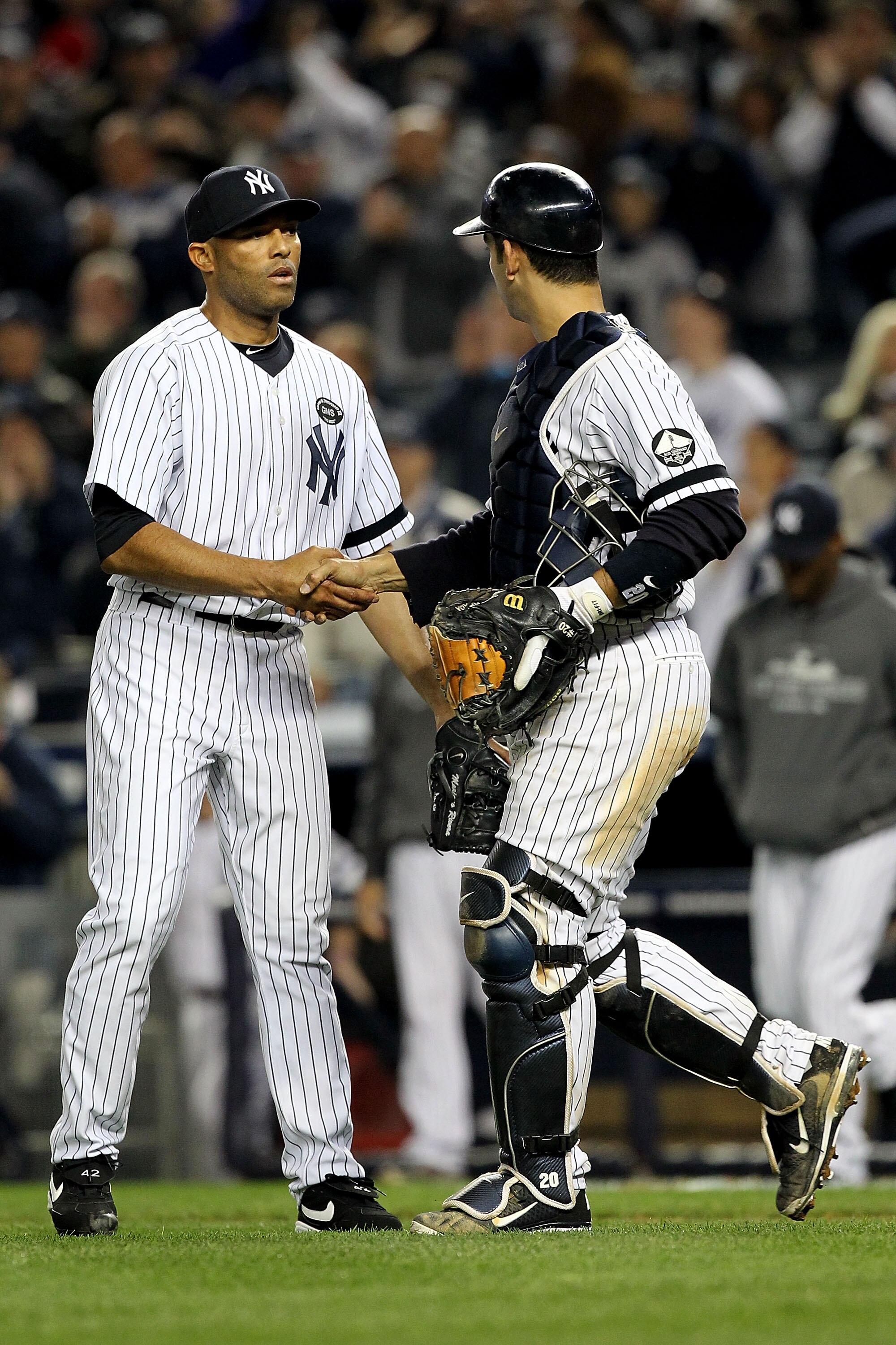 NEW YORK - OCTOBER 20:  Mariano Rivera #42 and Jorge Posada #20 of the New York Yankees celebrate after the Yankees won 7-2 against the Texas Rangers in Game Five of the ALCS during the 2010 MLB Playoffs at Yankee Stadium on October 20, 2010 in the Bronx