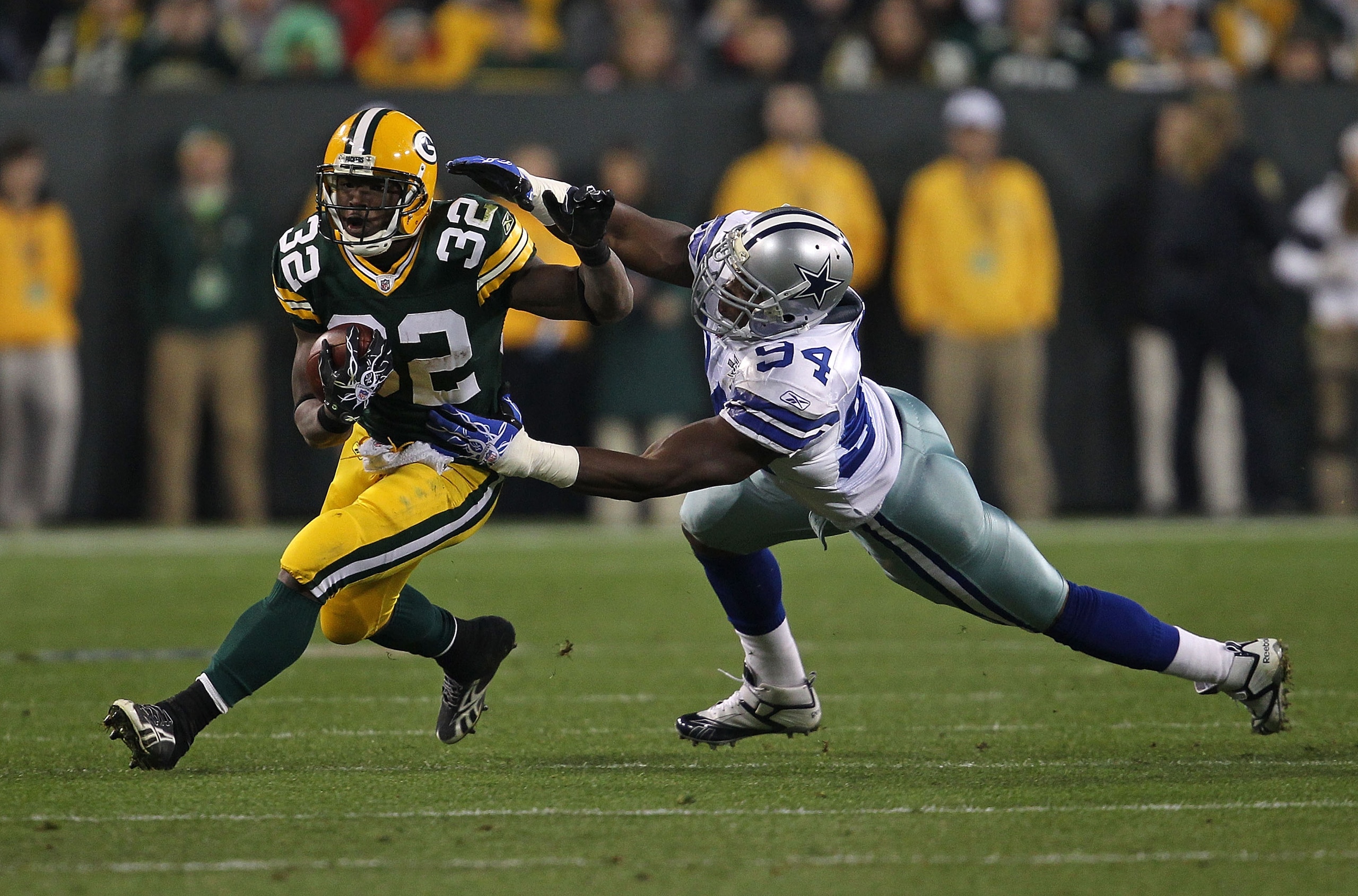 GREEN BAY, WI - NOVEMBER 07: Brandon Jackson #32 of the Green Bay Packers breaks away from DeMarcus Ware #94 of the Dallas Cowboys at Lambeau Field on November 7, 2010 in Green Bay, Wisconsin. (Photo by Jonathan Daniel/Getty Images)