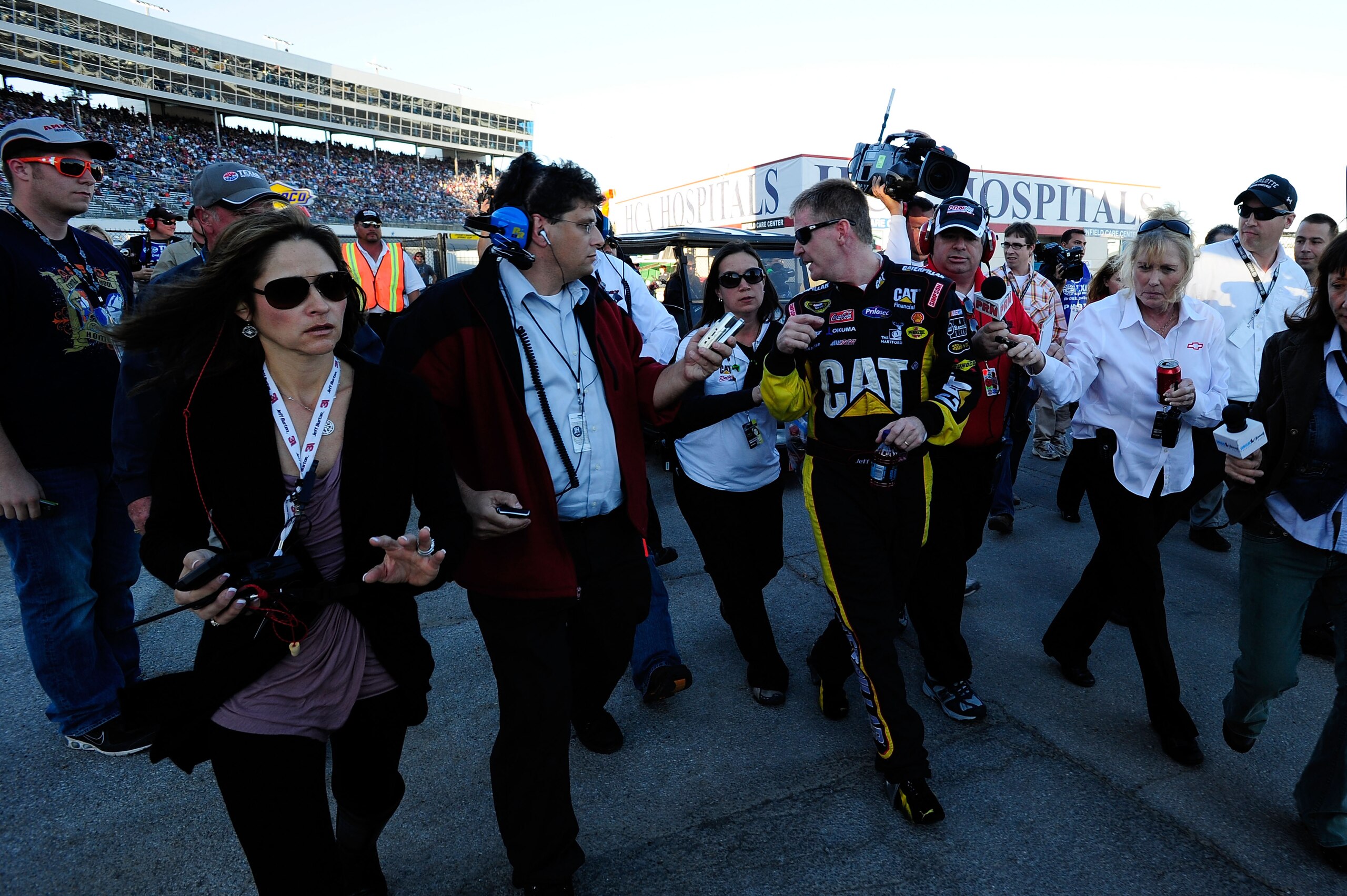 FORT WORTH, TX - NOVEMBER 07: Jeff Burton, driver of the #31 Caterpillar Chevrolett, talks to the media as he walks from the infield care center after an incident with Jeff Gordon in the NASCAR Sprint Cup Series AAA Texas 500 at Texas Motor Speedway on N FORT WORTH, TX - NOVEMBER 07: Jeff Burton, driver of the #31 Caterpillar Chevrolett, talks to the media as he walks from the infield care center after an incident with Jeff Gordon in the NASCAR Sprint Cup Series AAA Texas 500 at Texas Motor Speedway on N