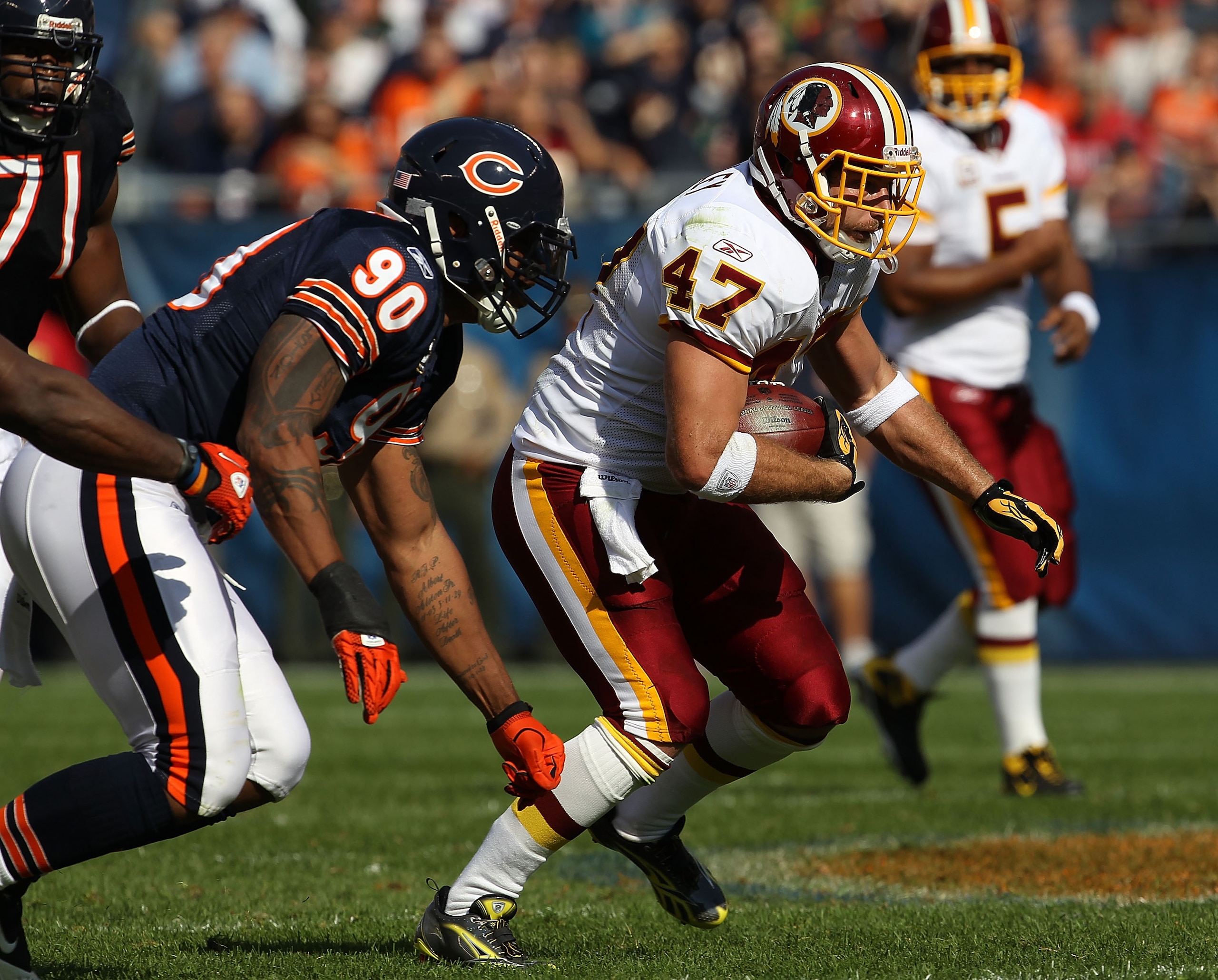 CHICAGO - OCTOBER 24: Chris Cooley #47 of the Washington Redskins runs pursued by Julius Peppers #90 of the Chicago Bears at Soldier Field on October 24, 2010 in Chicago, Illinois. The Redskins defeated the Bears 17-14. (Photo by Jonathan Daniel/Getty Ima