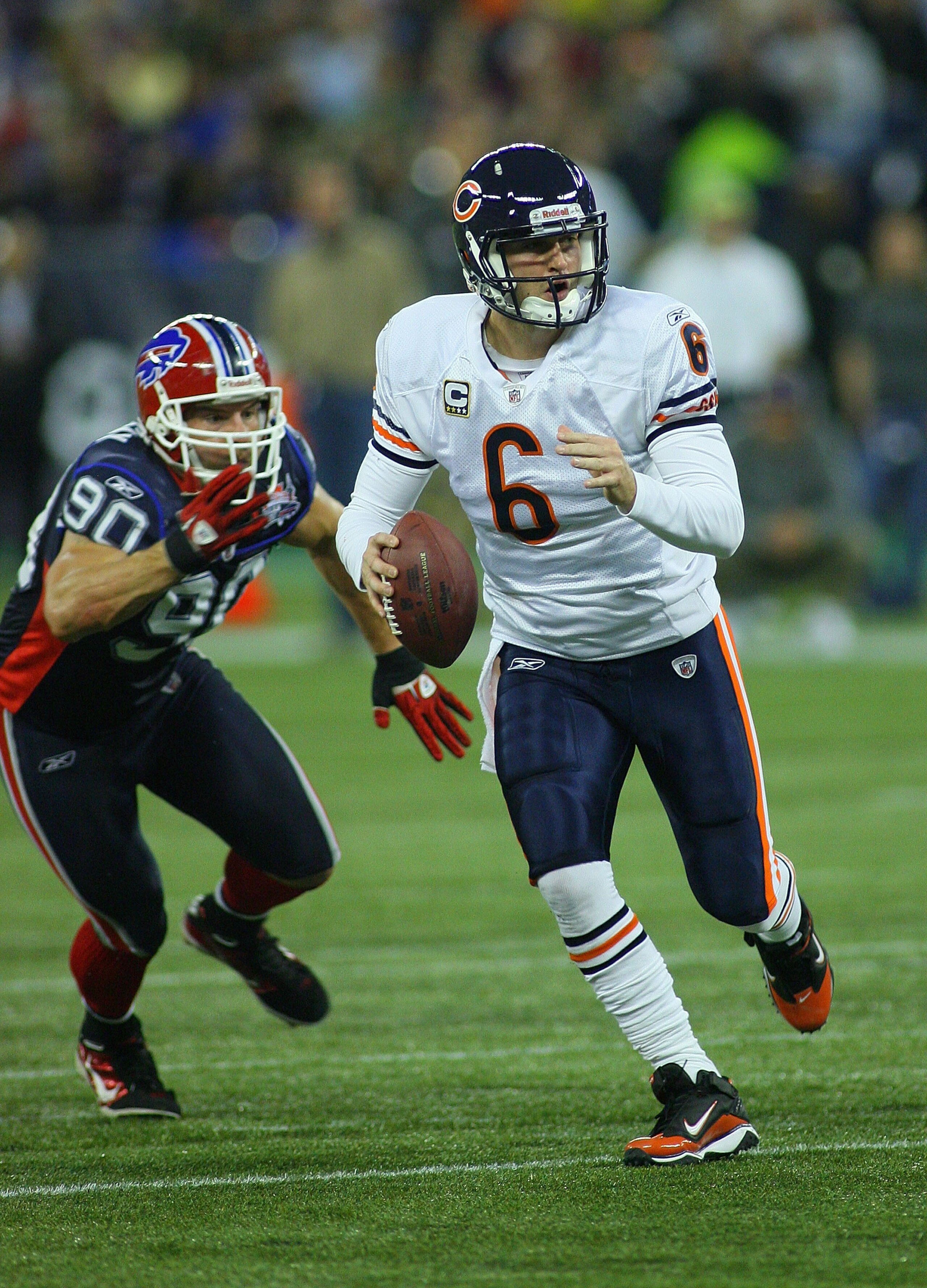 TORONTO, ON - NOVEMBER 07:  Jay Cutler # 6 of the Chicago Bears scrambles ahead of Chris Kelsay #90 of the Buffalo Bills  at Rogers Centre on November 7, 2010 in Toronto, Canada. Chicago won 22-19. (Photo by Rick Stewart/Getty Images)