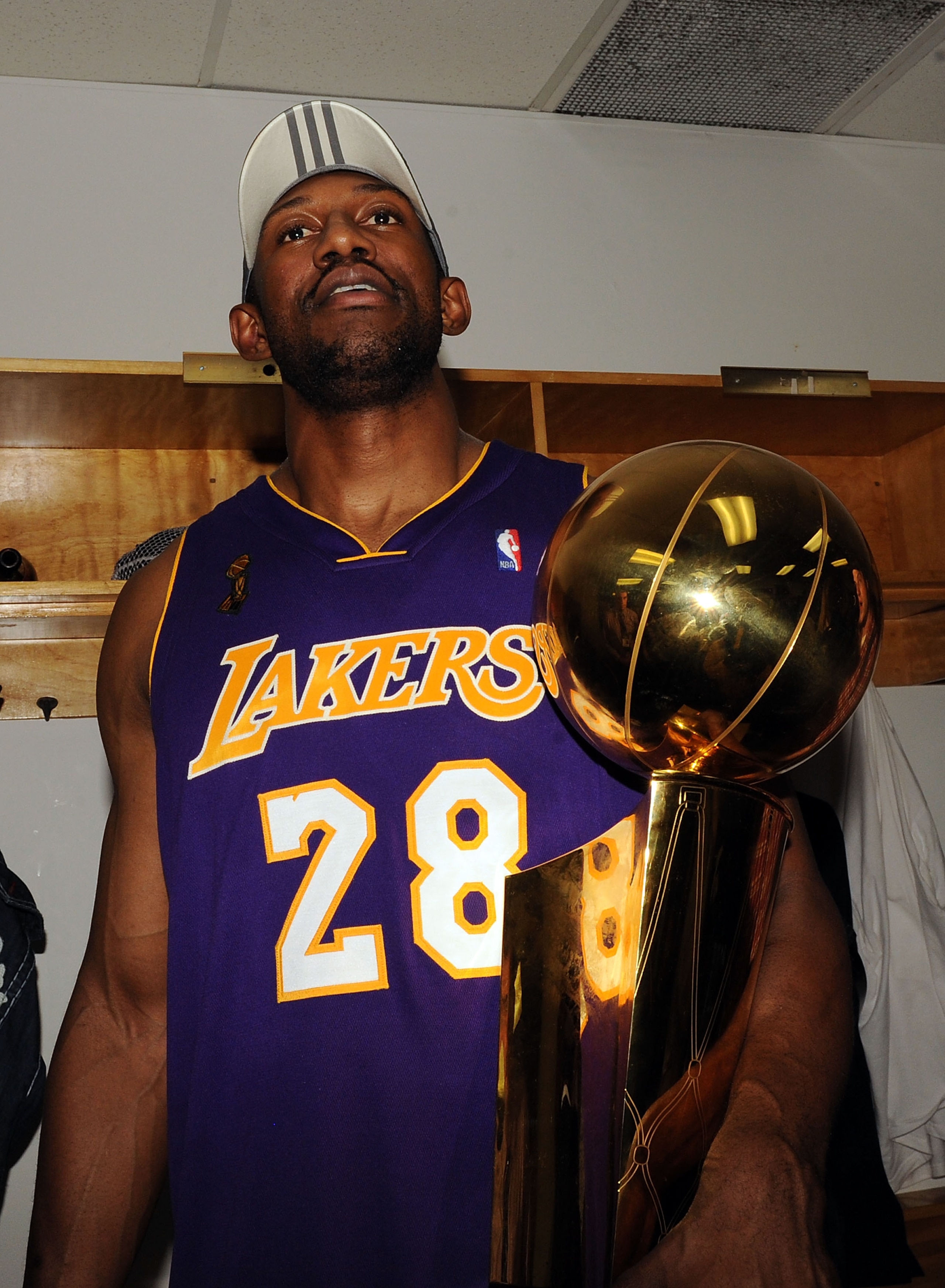 ORLANDO, FL - JUNE 14: Didier Ilunga-Mbenga #28 of the Los Angeles Lakers holds the Larry O'Brien trophy in the locker room after the Lakers defeated the Orlando Magic 99-86 in Game Five of the 2009 NBA Finals on June 14, 2009 at Amway Arena in Orlando, ORLANDO, FL - JUNE 14: Didier Ilunga-Mbenga #28 of the Los Angeles Lakers holds the Larry O'Brien trophy in the locker room after the Lakers defeated the Orlando Magic 99-86 in Game Five of the 2009 NBA Finals on June 14, 2009 at Amway Arena in Orlando,