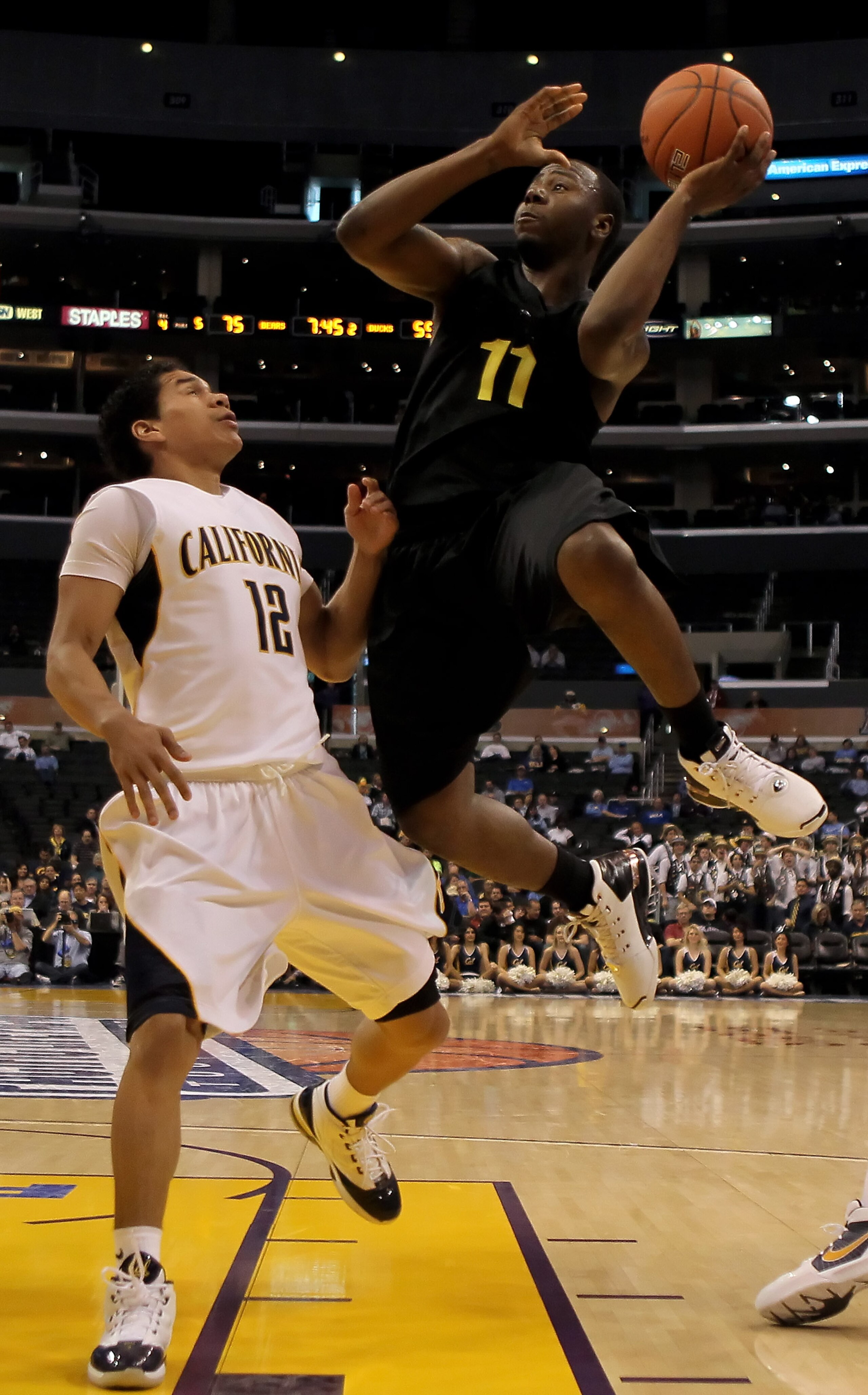 LOS ANGELES, CA - MARCH 11:  Malcolm Armstead #11 of the Oregon ducks shoots over Brandon Smith #12 of the Cal Golden Bears in the second half during the Quarterfinals of the Pac-10 Basketball Tournament at Staples Center on March 11, 2010 in Los Angeles,