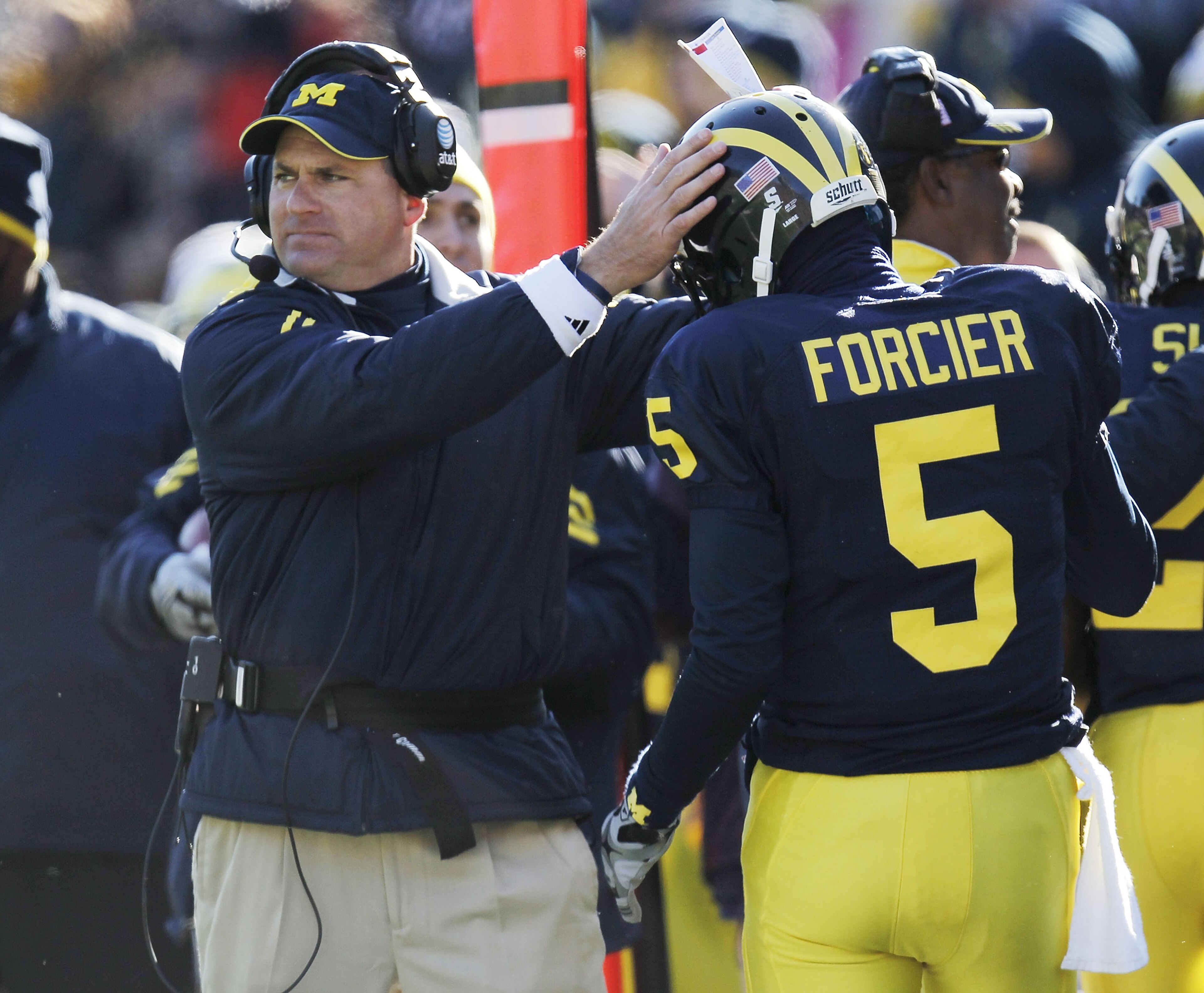 ANN ARBOR, MI - NOVEMBER 06:  Tate Forcier #5 of the Michigan Wolverines is congratulated by head coach Rich Rodriguez after scoring an overtime touchdown while playing the Illinios Fighting Illini at Michigan Stadium on November 6, 2010 in Ann Arbor, Mic