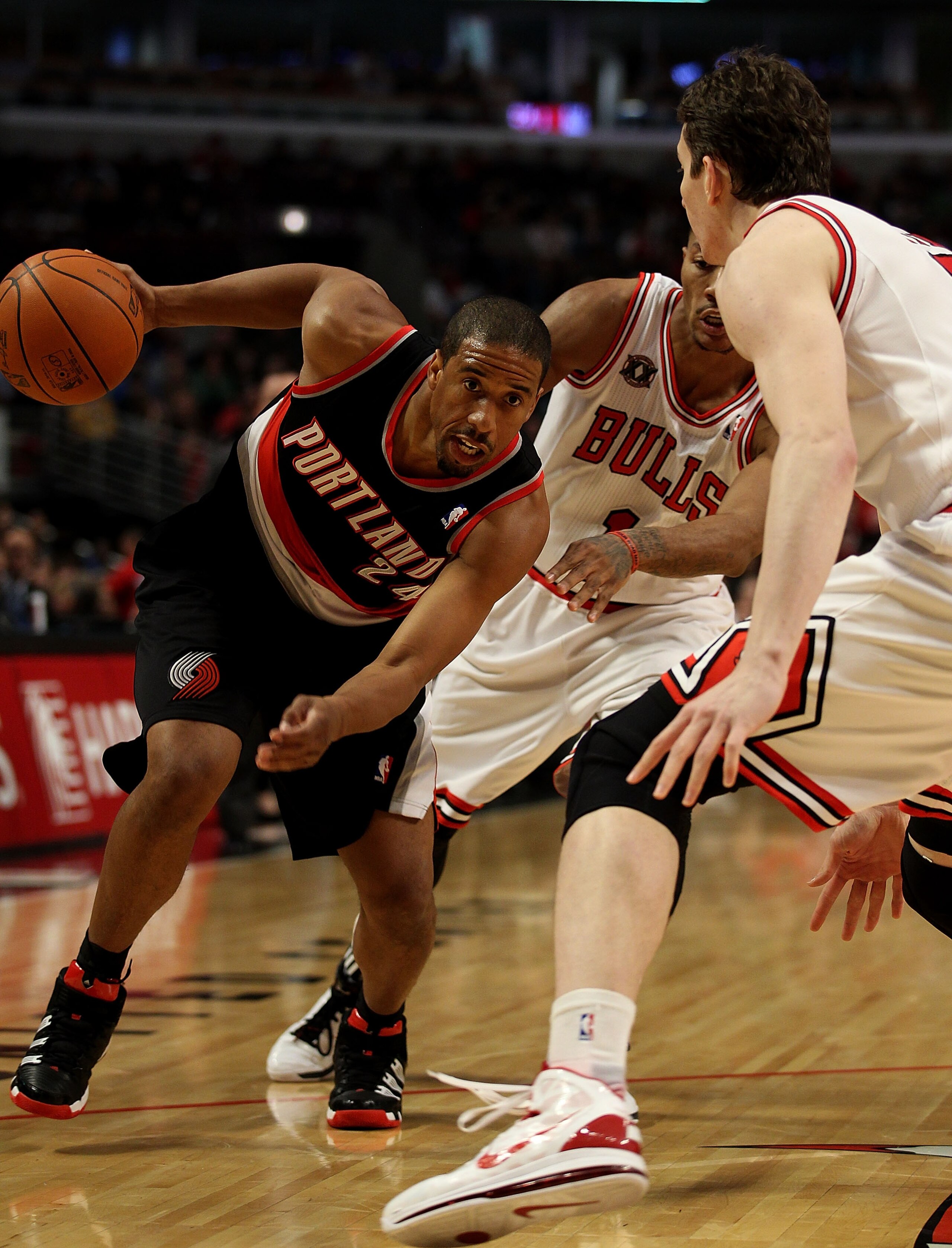 CHICAGO - NOVEMBER 01: Andre Miller #24 of the Portland Trail Blazers drives against Derrick Rose #1 and Omer Asik #3 of the Chicago Bulls at the United Center on November 1, 2010 in Chicago, Illinois. NOTE TO USER: User expressly acknowledges and agrees