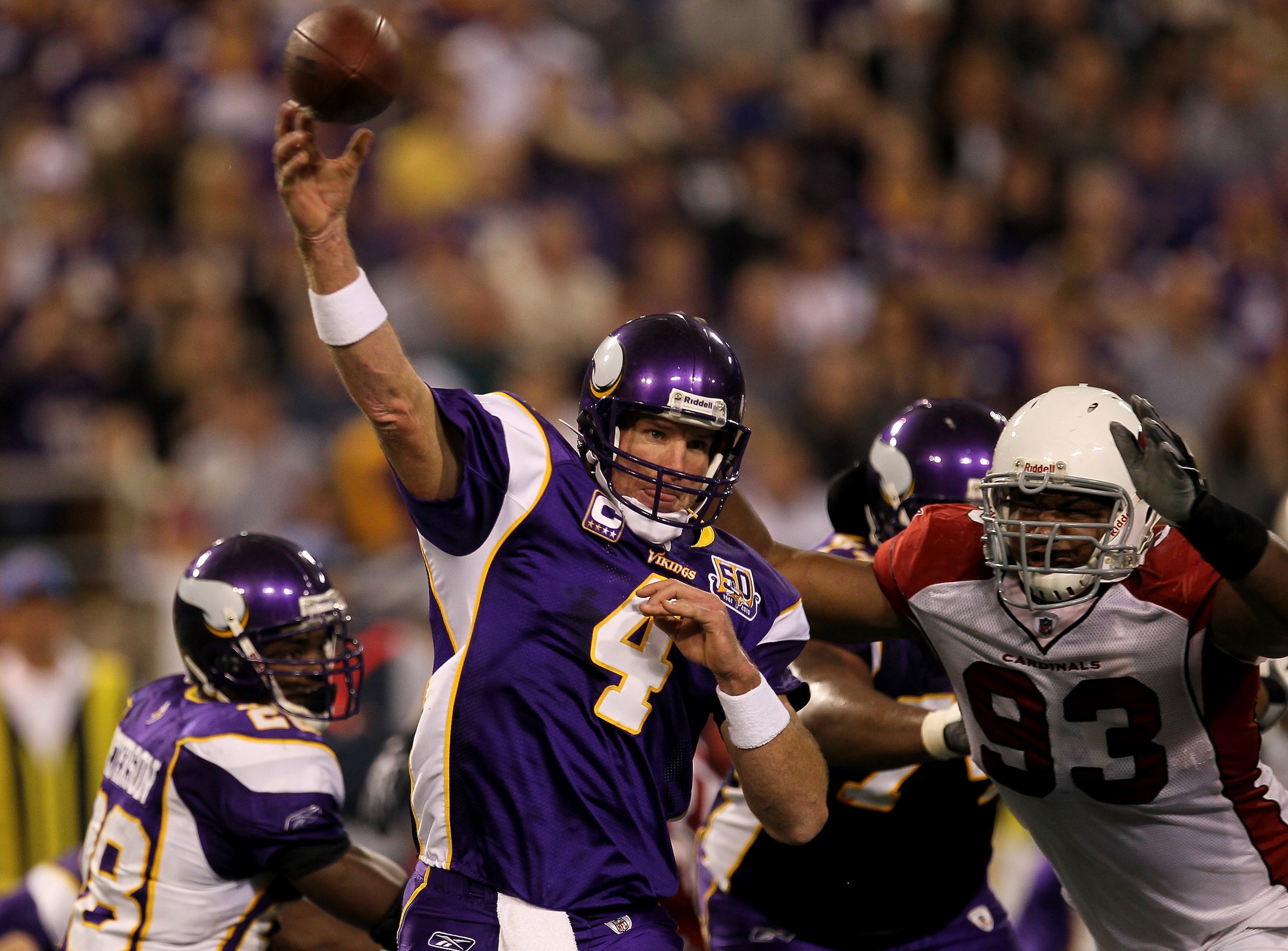 MINNEAPOLIS - NOVEMBER 07:  Quarterback Brett Favre #4 of the Minnesota Vikings throws a pass as defensive end Calais Campbell #93 of the Arizona Cardinals closes in at Hubert H. Humphrey Metrodome on November 7, 2010 in Minneapolis, Minnesota.  (Photo by