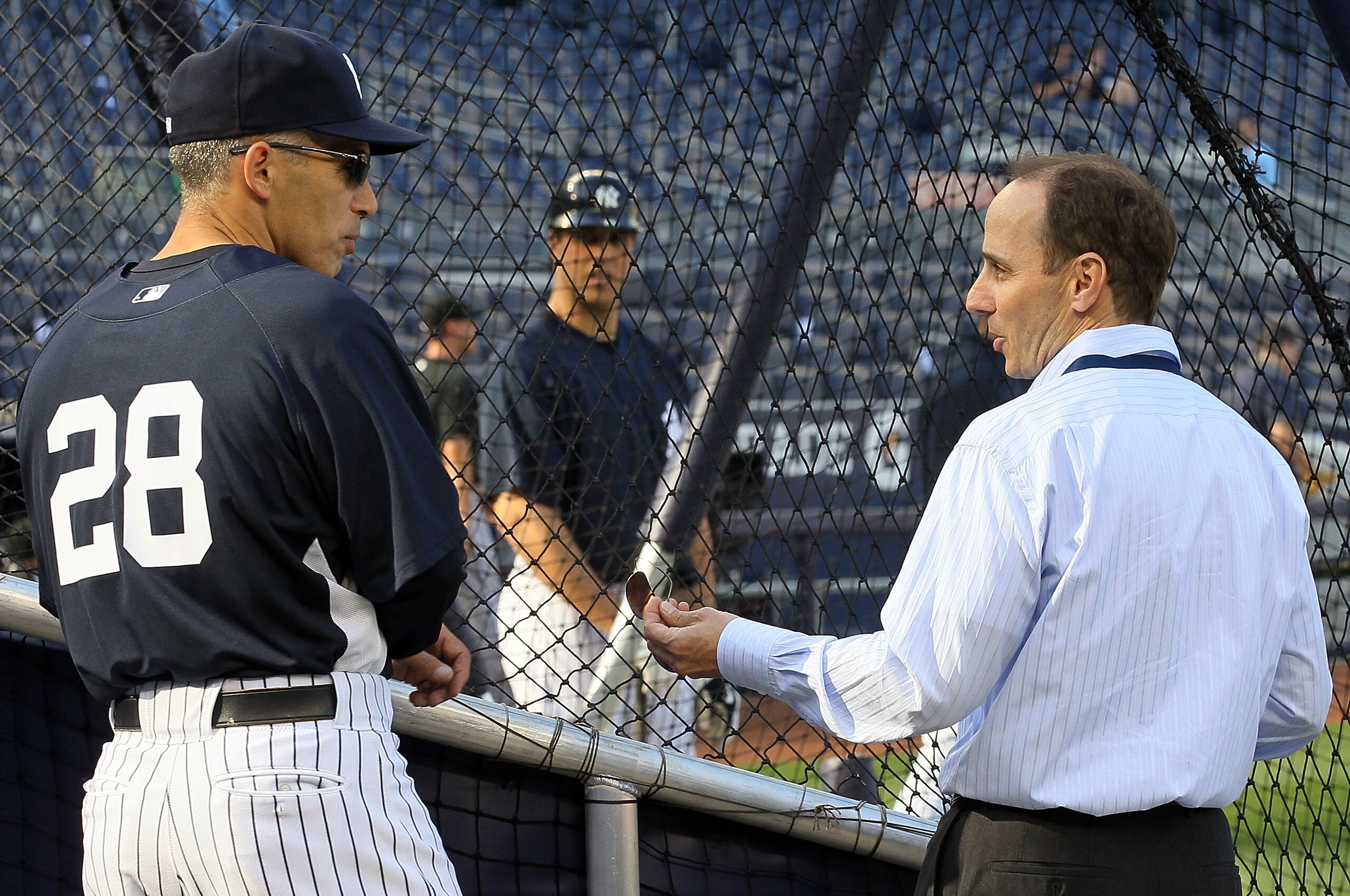 NEW YORK - APRIL 30: Manager Joe Girardi of the New York Yankees talks with Yankee general manager Brian Cashman during batting practice prior to the game against the Chicago White Sox on April 30, 2010 at Yankee Stadium in the Bronx borough of New York NEW YORK - APRIL 30: Manager Joe Girardi of the New York Yankees talks with Yankee general manager Brian Cashman during batting practice prior to the game against the Chicago White Sox on April 30, 2010 at Yankee Stadium in the Bronx borough of New York