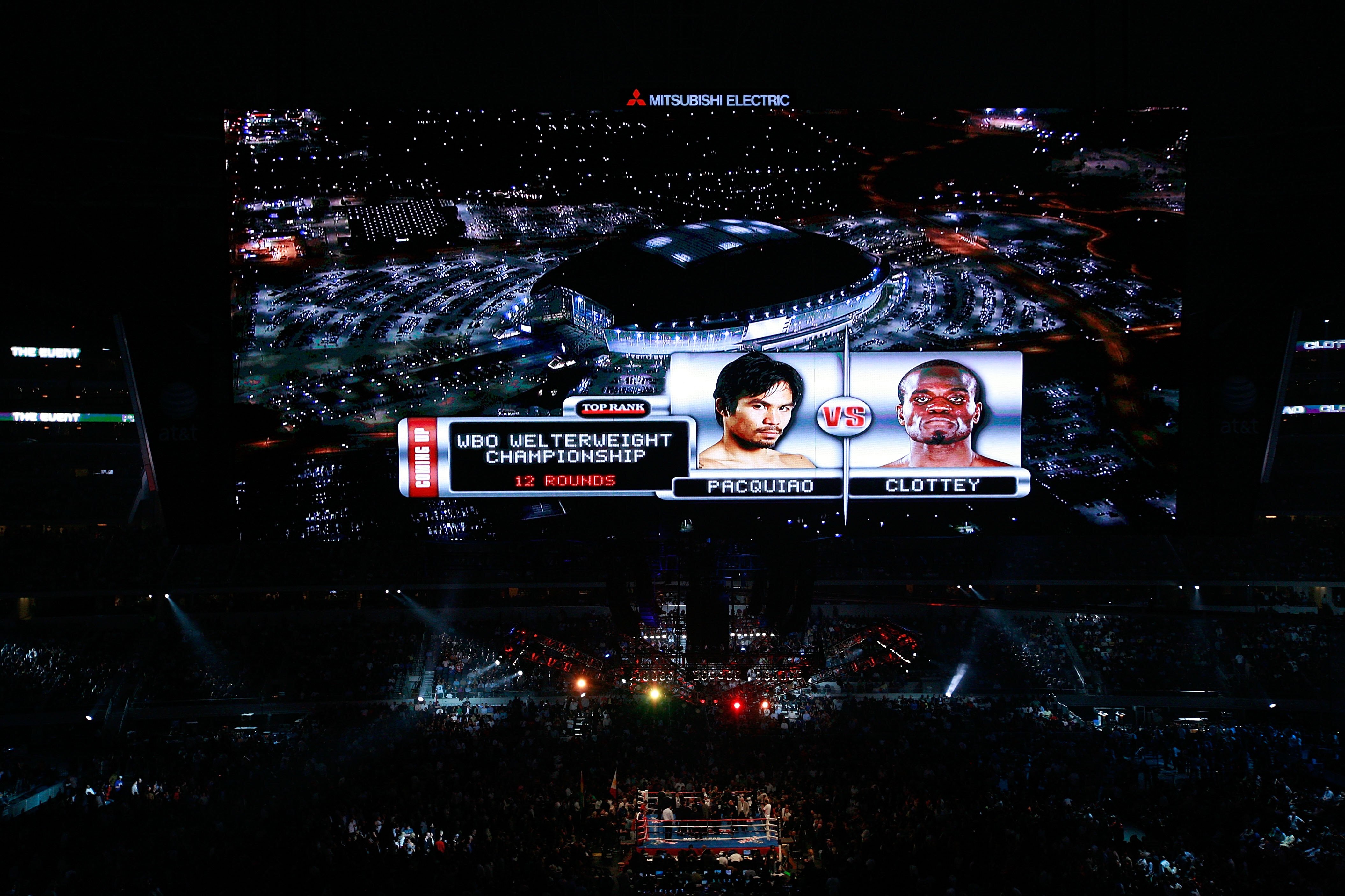 ARLINGTON, TX - MARCH 13:  The video screen previews the fight between Manny Pacquiao of the Philippines and Joshua Clottey of Ghana before their WBO welterweight title fight at Cowboys Stadium on March 13, 2010 in Arlington, Texas.  (Photo by Tom Penning