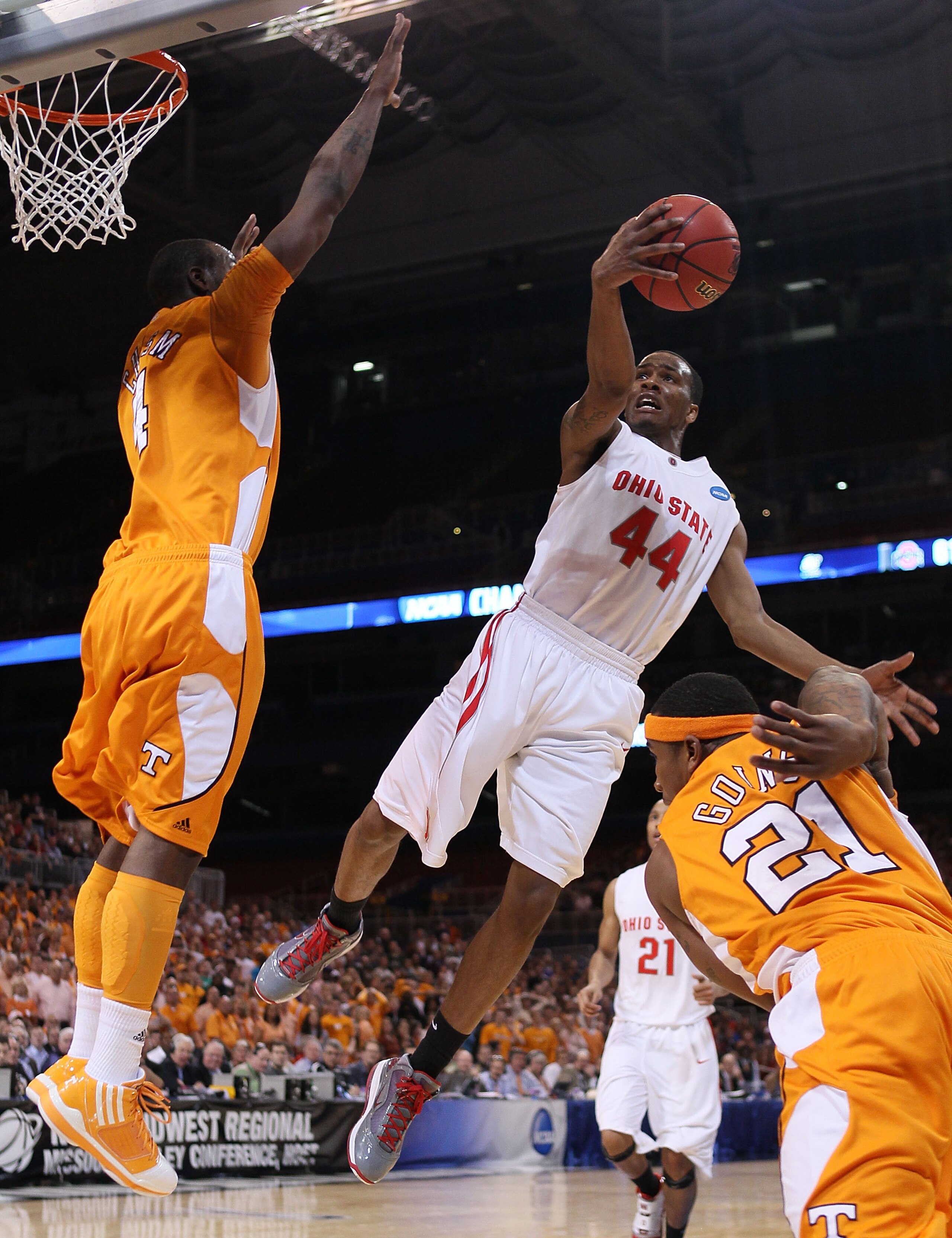 ST. LOUIS - MARCH 26:  William Buford #44 of the Ohio State Buckeyes goes up for a shot as Melvin Goins #21 and Wayne Chism #4 of the Tennessee Volunteers defend during the midwest regional semifinal of the 2010 NCAA men's basketball tournament at the Edw