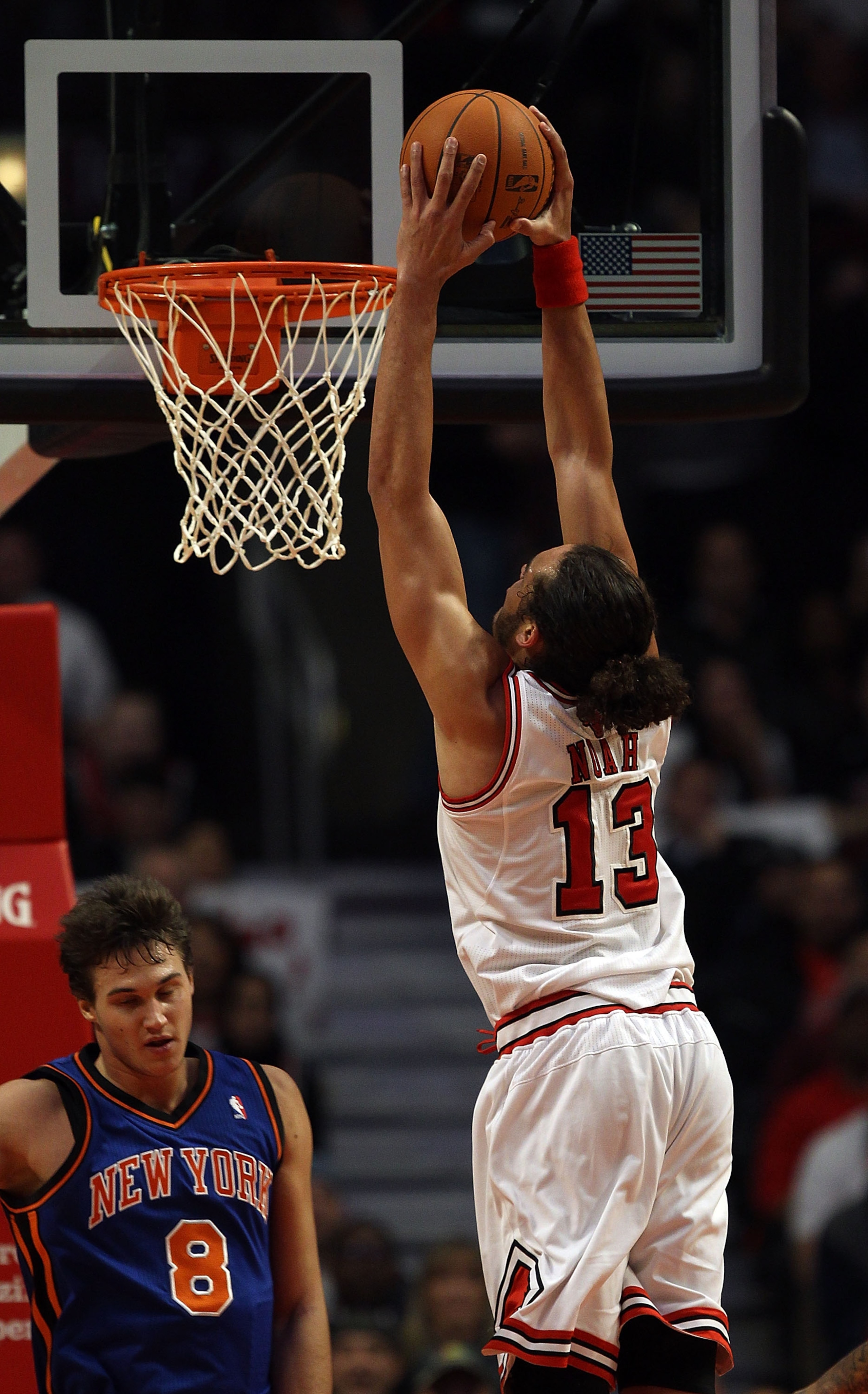 CHICAGO - NOVEMBER 04: Joakim Noah #13 of the Chicago Bulls goes up for a dunk over Danilo Gallinari #8 of the New York Knicks at the United Center on November 4, 2010 in Chicago, Illinois. The Knicks defeated the Bulls 120-112. NOTE TO USER: User express