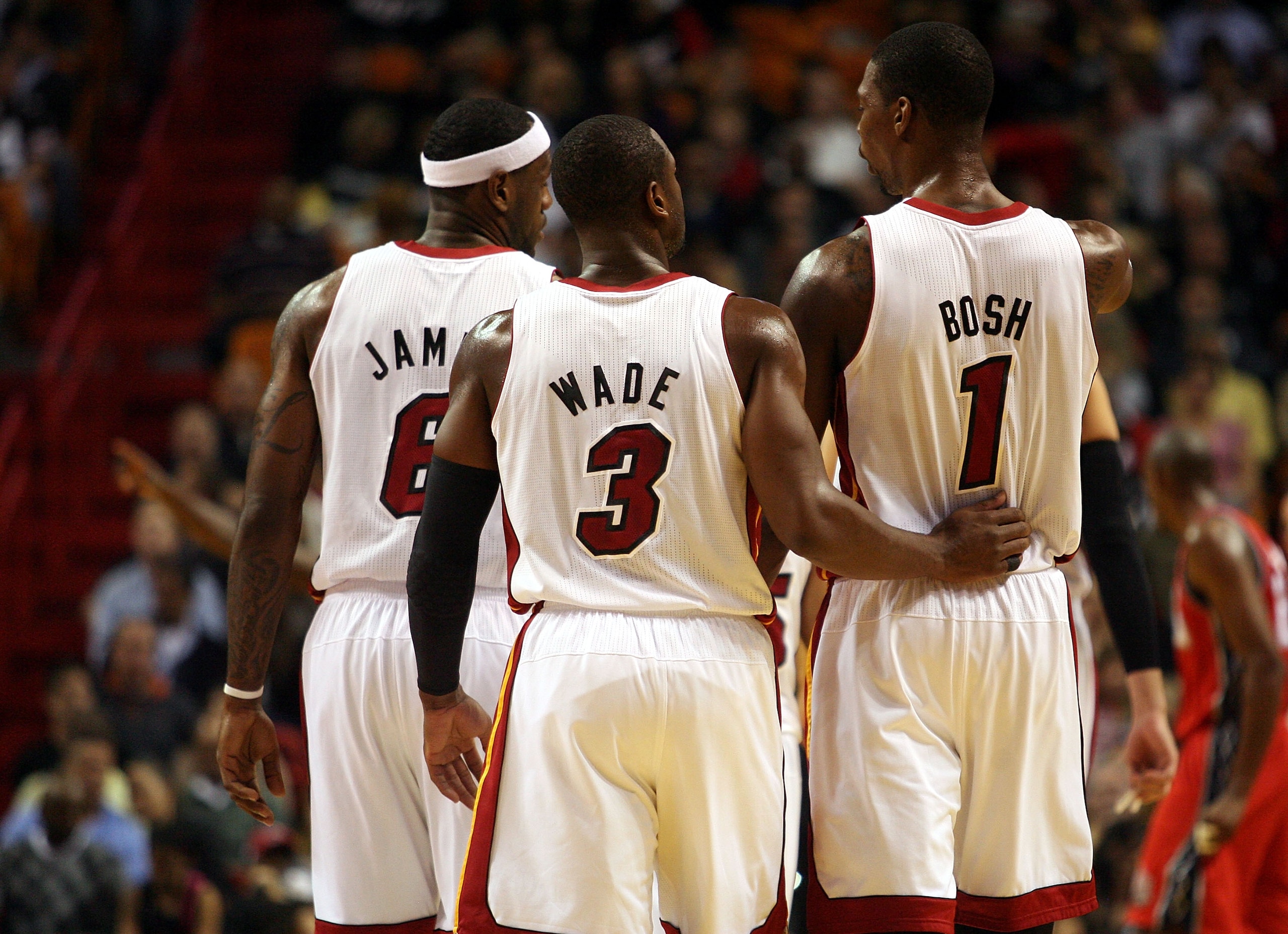 MIAMI - NOVEMBER 06: Dwyane Wade #3, LeBron James #6 and Chris Bosh #1 of the Miami Heat chat during a game against the New Jersey Nets  at American Airlines Arena on November 6, 2010 in Miami, Florida. NOTE TO USER: User expressly acknowledges and agrees