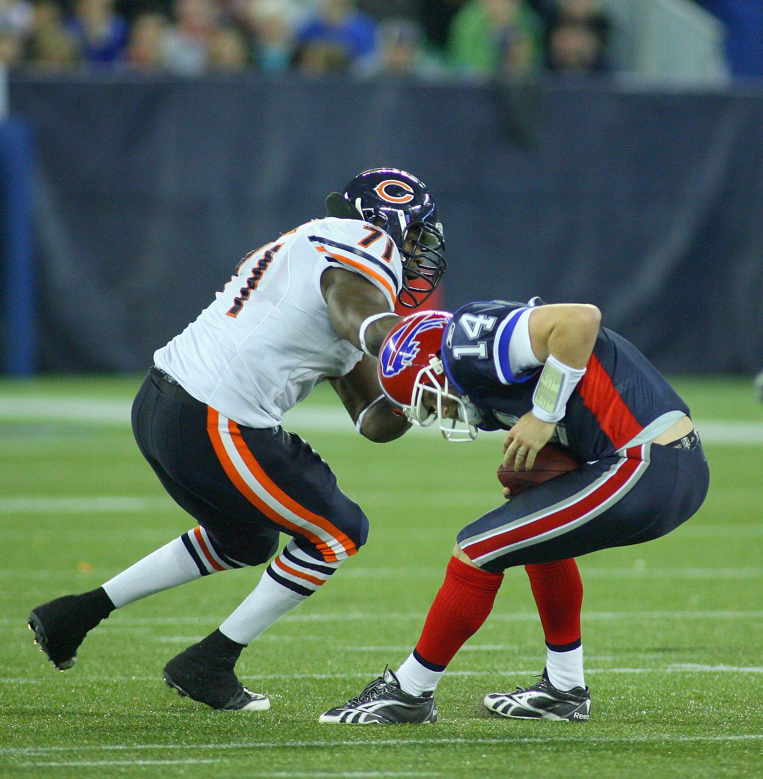 TORONTO, ON - NOVEMBER 07:  Ryan Fitzpatrick #14 of the Buffalo Bills slips away from Israel Idonije #71 of  the Chicago Bears at Rogers Centre on November 7, 2010 in Toronto, Canada. Chicago won 22-19.  (Photo by Rick Stewart/Getty Images)
