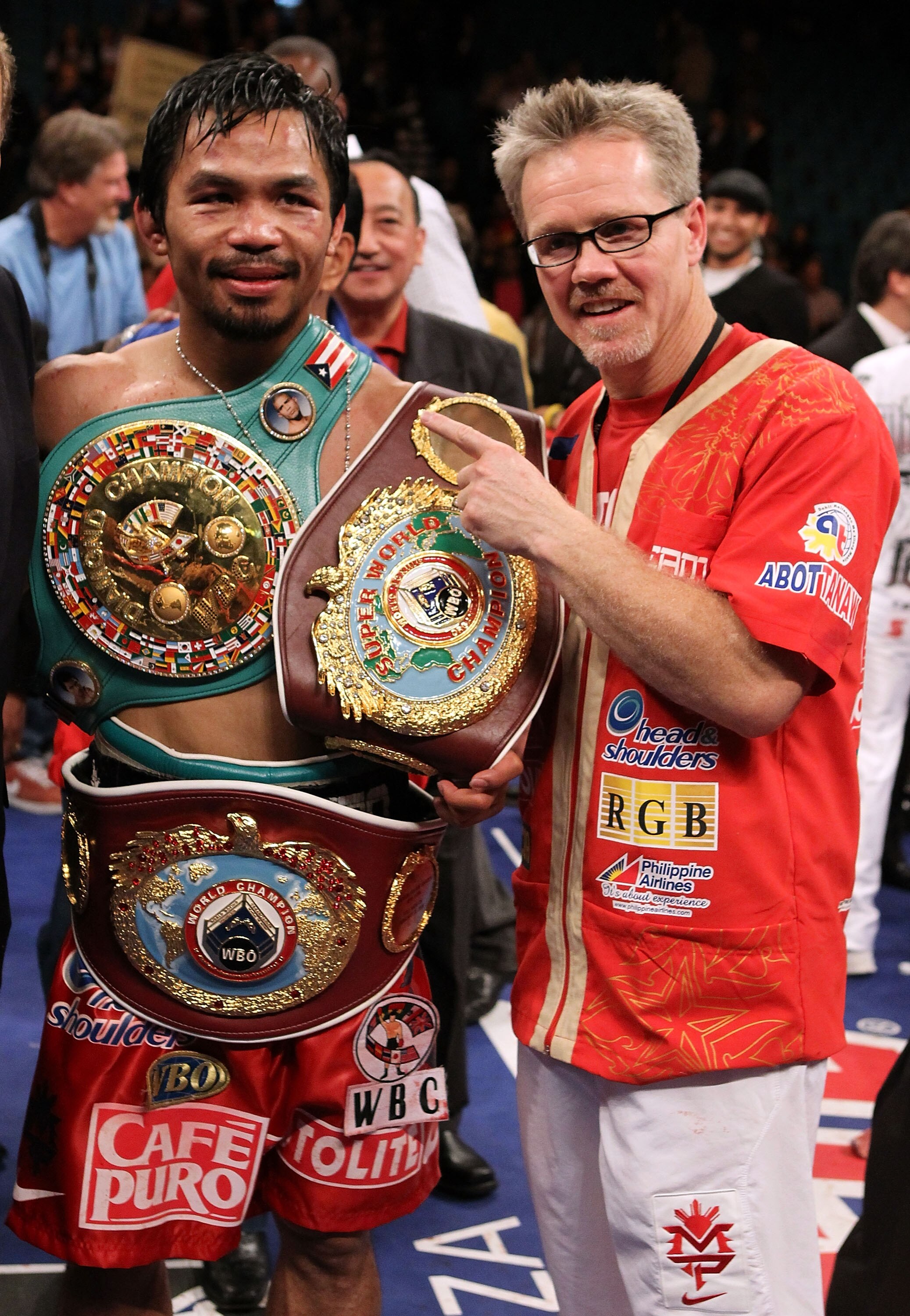 LAS VEGAS - NOVEMBER 14:  Manny Pacquiao celebrates his 12 round TKO victory against Miguel Cotto with trainer Freddy Roach during their WBO welterweight title fight at the MGM Grand Garden Arena on November 14, 2009 in Las Vegas, Nevada.  (Photo by Al Be