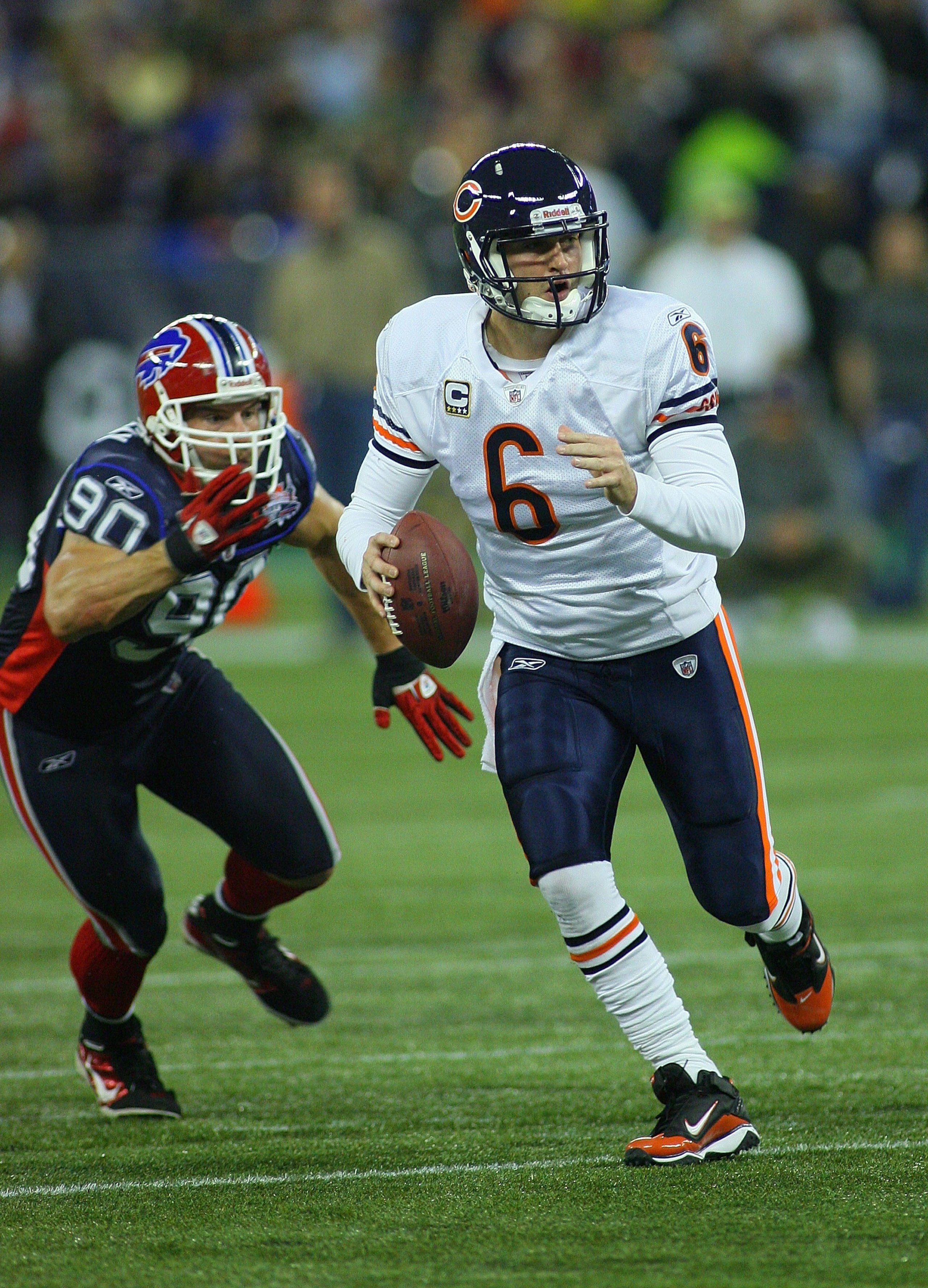 TORONTO, ON - NOVEMBER 07:  Jay Cutler # 6 of the Chicago Bears scrambles ahead of Chris Kelsay #90 of the Buffalo Bills  at Rogers Centre on November 7, 2010 in Toronto, Canada. Chicago won 22-19. (Photo by Rick Stewart/Getty Images)
