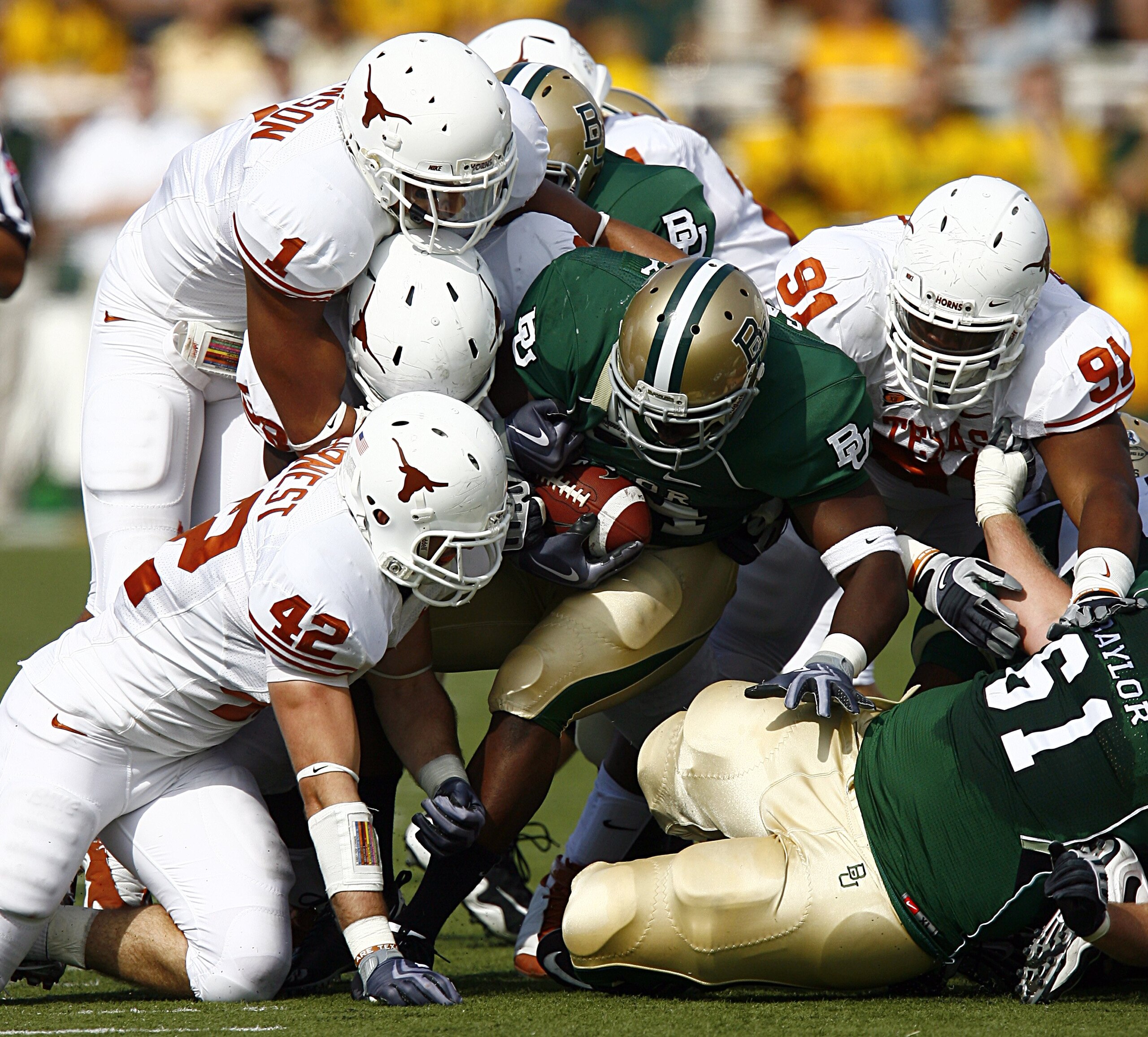 WACO, TX - NOVEMBER 14: Running back Terrance Ganaway #24 of the Baylor Bears carries the ball against linebacker Dusting Earnest #42, linebacker Keenan Robinson #1, and tackle Kheeston Randall #91of the Texas Longhorns during the second half on Novembe WACO, TX - NOVEMBER 14: Running back Terrance Ganaway #24 of the Baylor Bears carries the ball against linebacker Dusting Earnest #42, linebacker Keenan Robinson #1, and tackle Kheeston Randall #91of the Texas Longhorns during the second half on Novembe