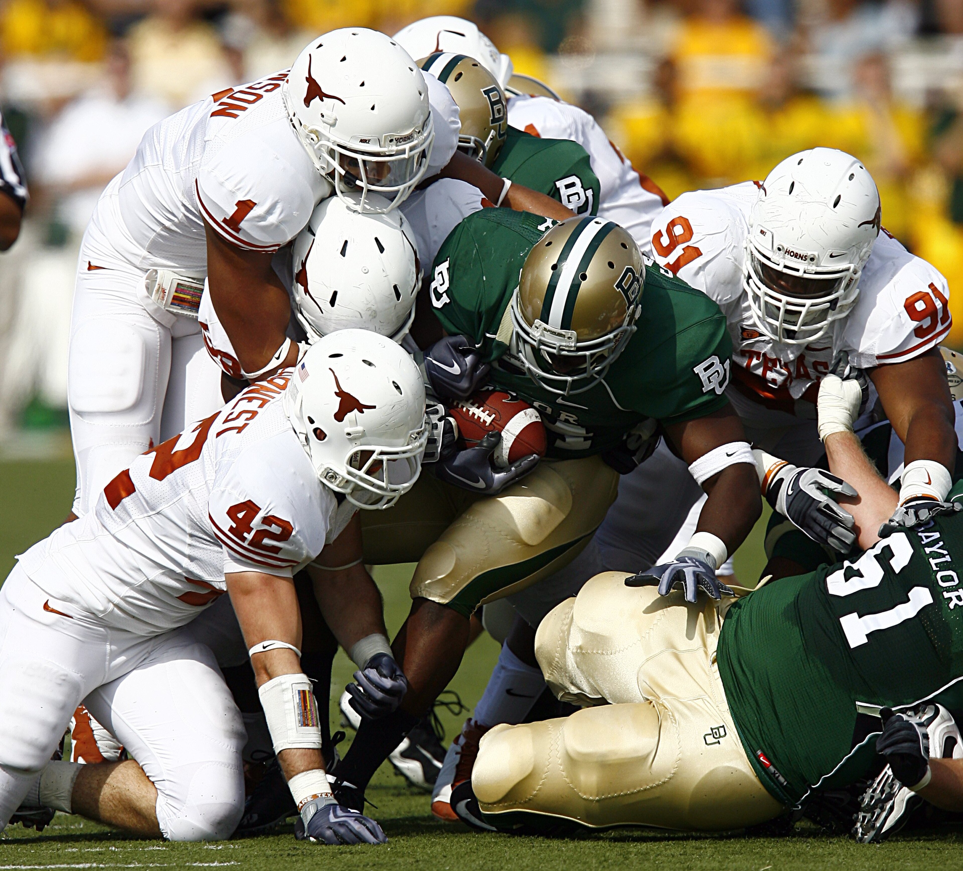 WACO, TX - NOVEMBER 14:  Running back Terrance Ganaway #24 of the Baylor Bears carries the ball against linebacker Dusting Earnest #42, linebacker Keenan Robinson #1, and tackle Kheeston Randall #91of the Texas Longhorns  during the second half on Novembe