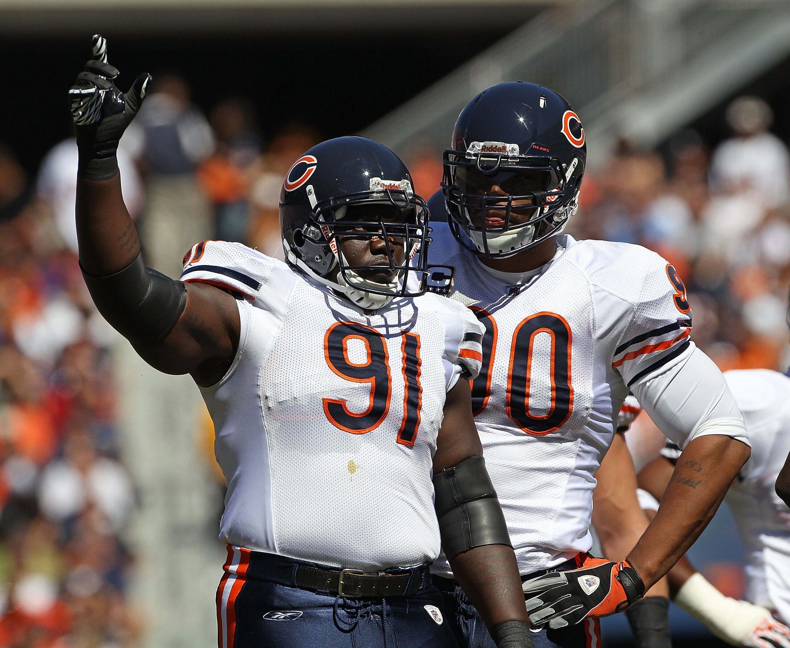 CHICAGO - SEPTEMBER 12: Tommie Harris #91 and Julius Peppers #90 of the Chicago Bears await the start of play against the Detroit Lions during the NFL season opening game at Soldier Field on September 12, 2010 in Chicago, Illinois. The Bears defeated the 
