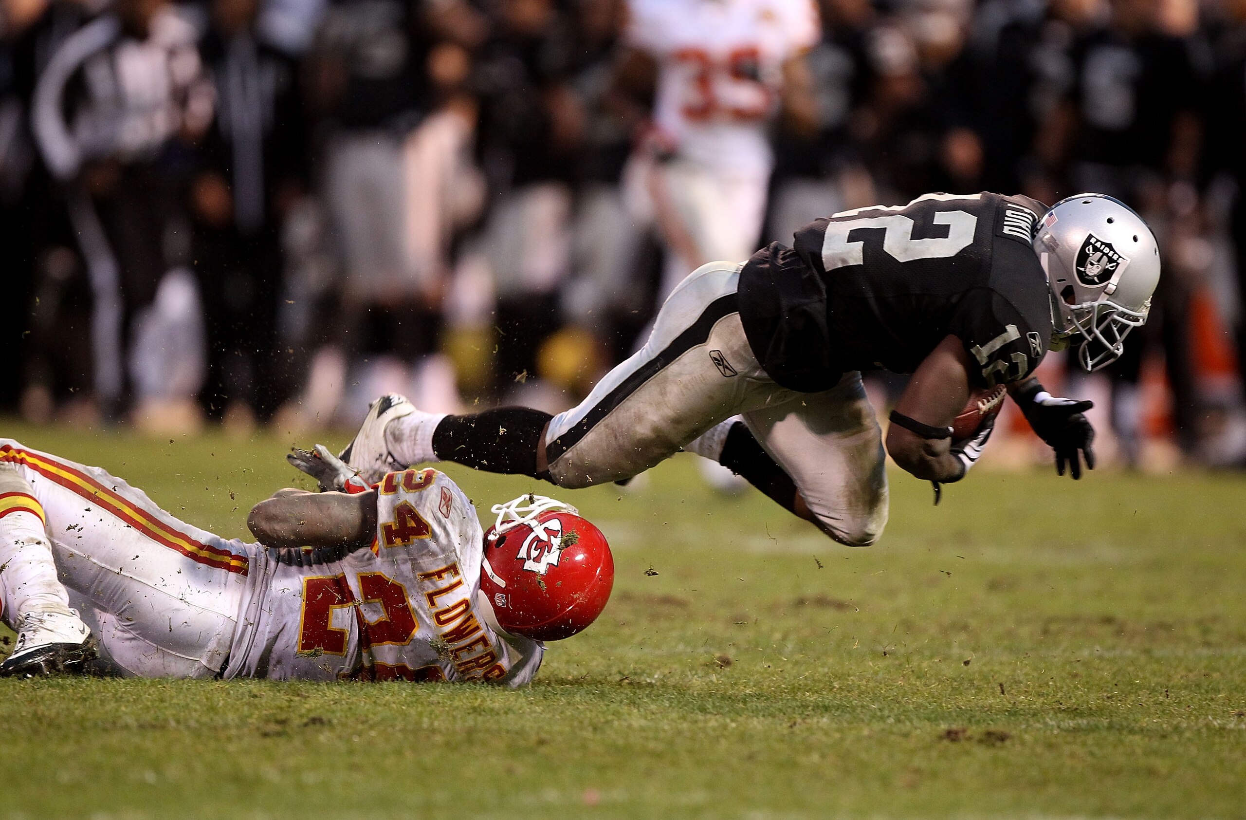 OAKLAND, CA - NOVEMBER 07:  Jacoby Ford #12 of the Oakland Raiders catches a pass over Brandon Flowers #24 of the Kansas City Chiefs in overtime during an NFL game at Oakland-Alameda County Coliseum on November 7, 2010 in Oakland, California.  (Photo by J