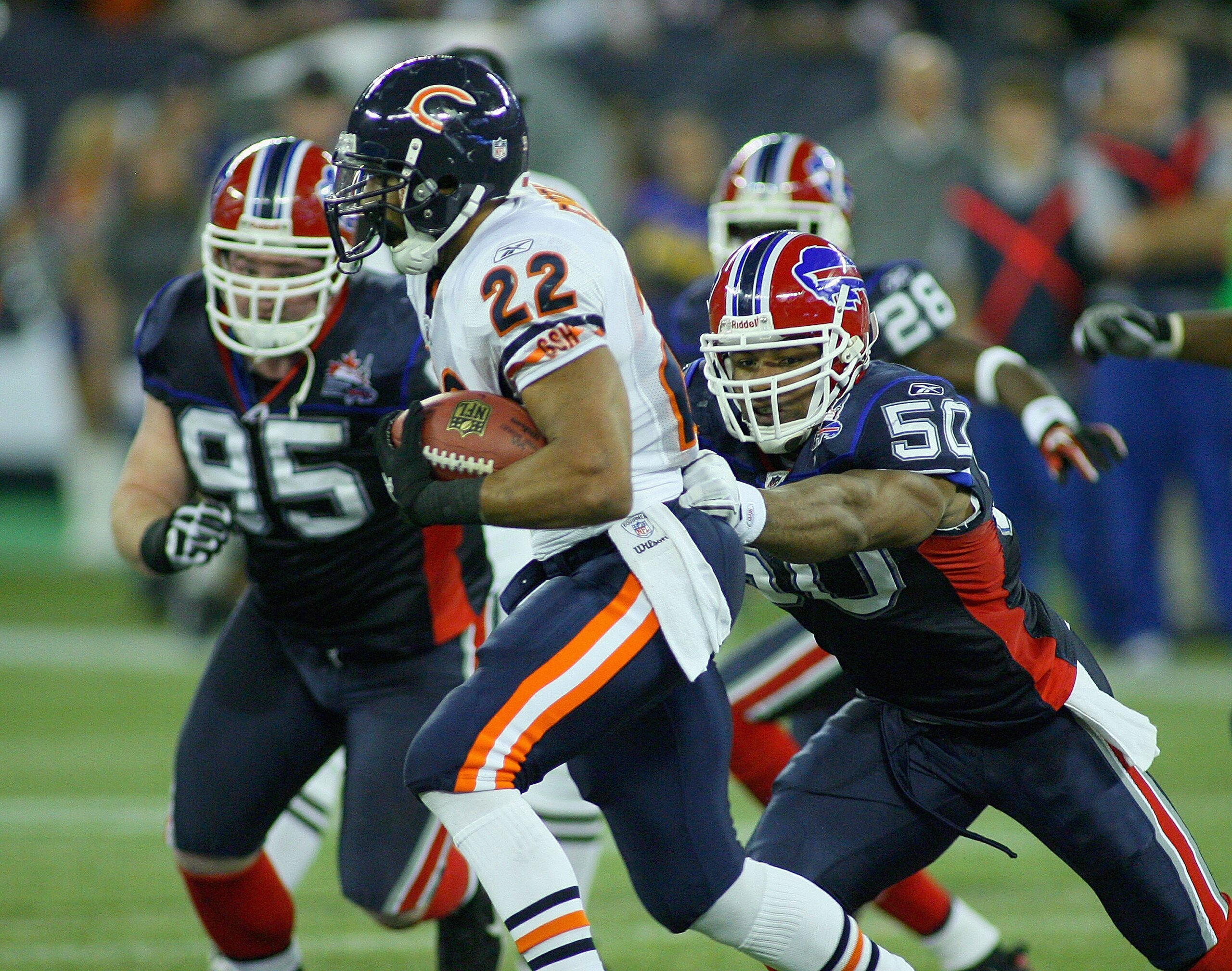 TORONTO, ON - NOVEMBER 07: Matt Forte #22 of the Chicago Bears runs away from Akin Ayodele #50 of the Buffalo Bills  at Rogers Centre on November 7, 2010 in Toronto, Canada. Chicago won 22-19.  (Photo by Rick Stewart/Getty Images)