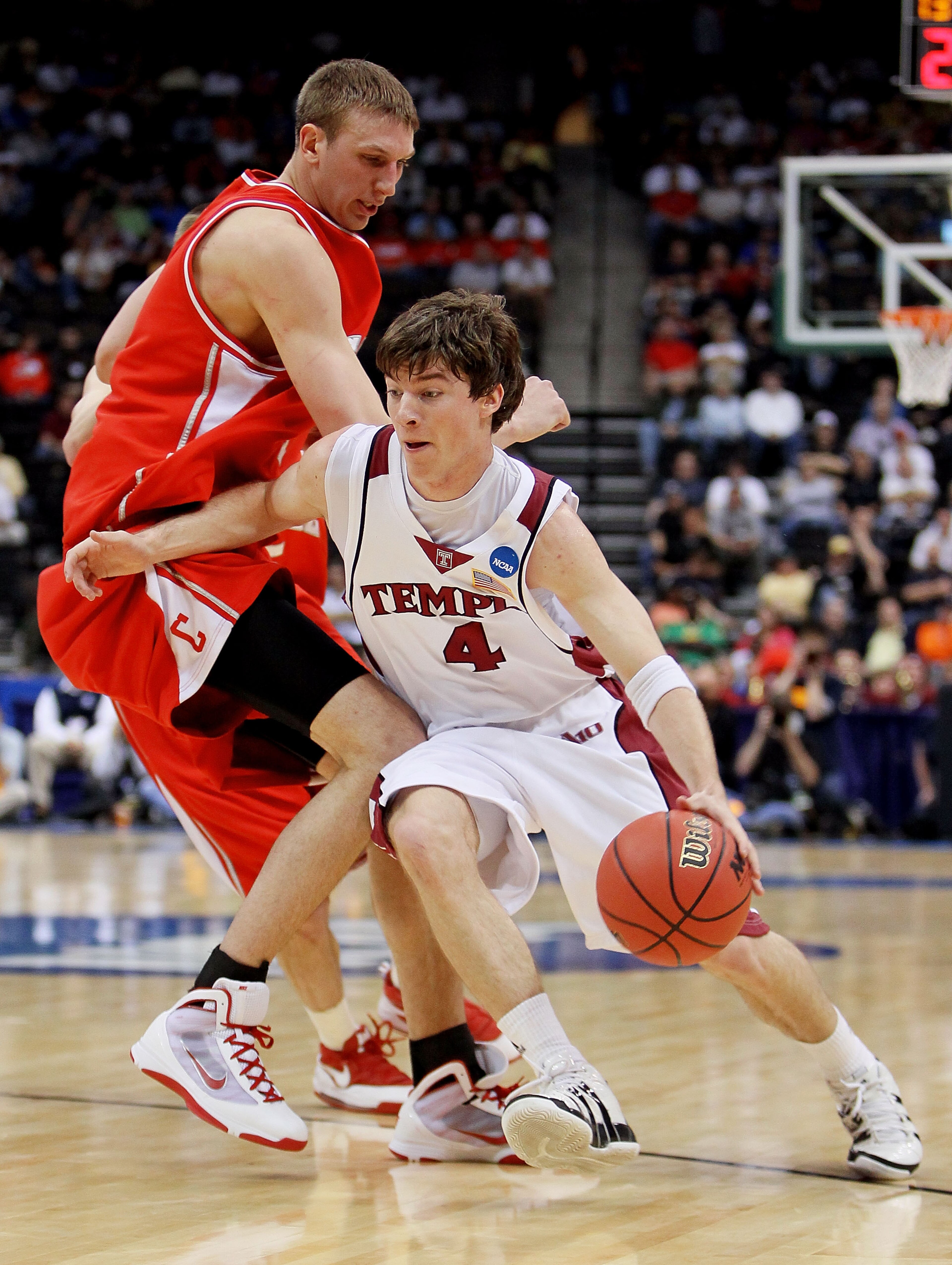 JACKSONVILLE, FL - MARCH 19:  Juan Fernandez #4 of the Temple Owls drives around Jeff Foote #1 of the Cornell Big Red during the first round of the 2010 NCAA men's basketball tournament at Jacksonville Veteran's Memorial Arena on March 19, 2010 in Jackson