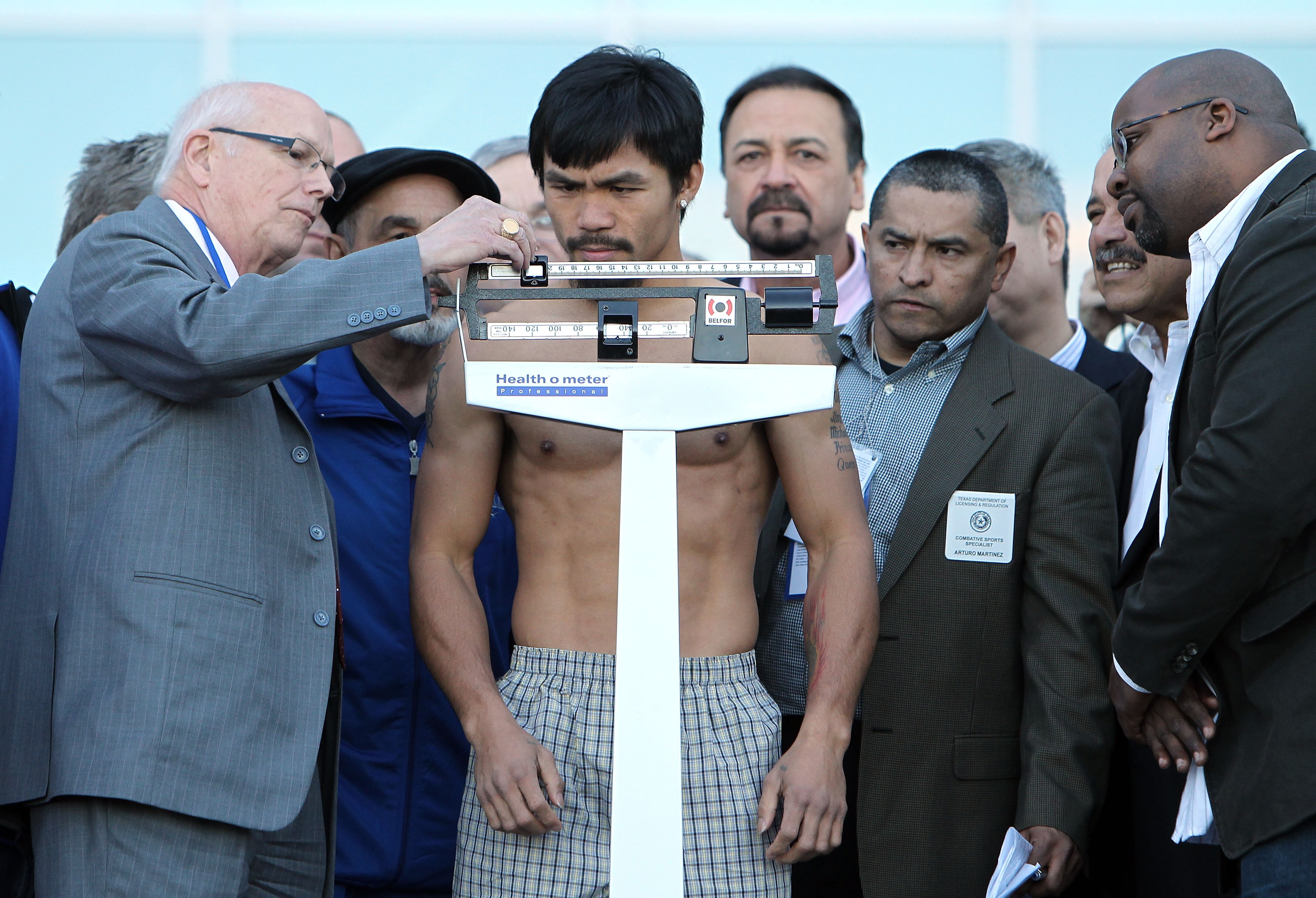 ARLINGTON, TX - MARCH 12:  Manny Pacquiao of the Philippines steps on the scale during the weigh-in for his WBO welterweight title fight against Joshua Clottey of Ghana outside Cowboys Stadium on March 12, 2010 in Arlington, Texas. Pacquiao and Clottey wi